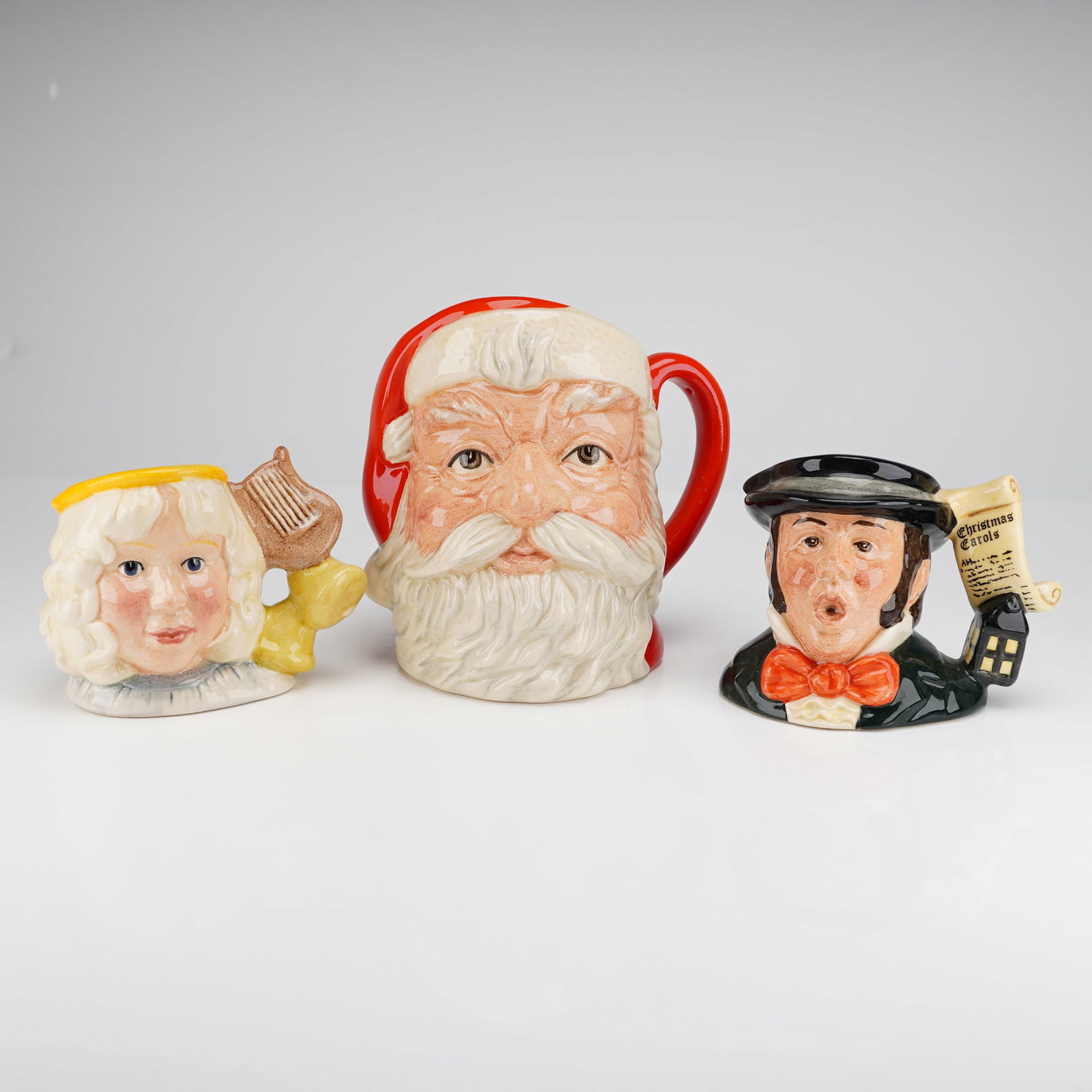3pc Royal Doulton Character Jugs, Santa, Caroler, and Angel (1 of 3)