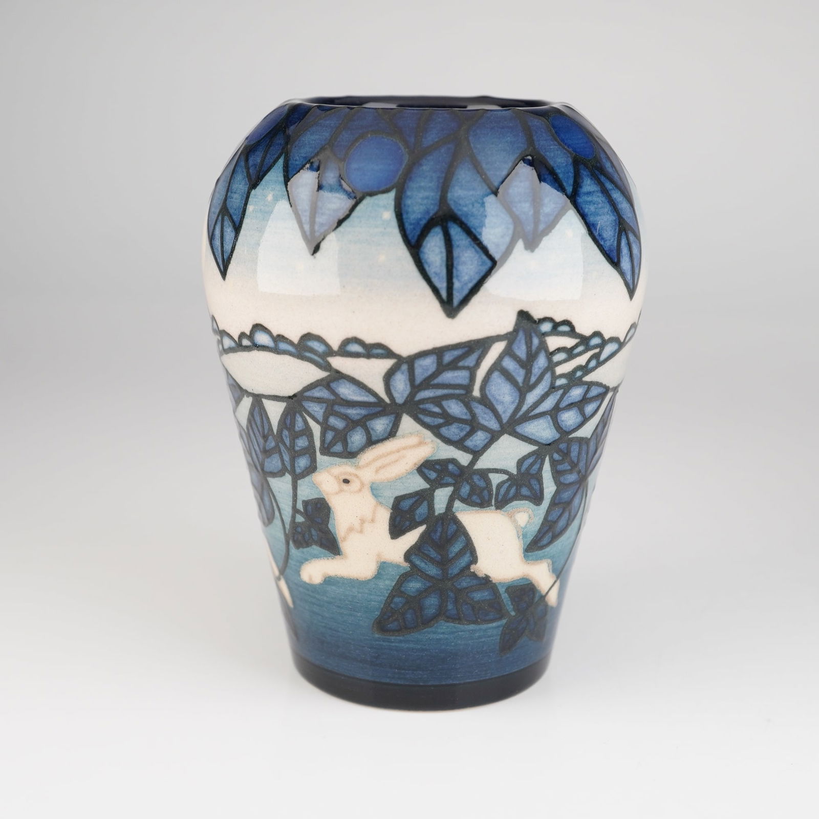 Dennis Chinaworks Sally Tuffin Rabbit Bud Vase: A Dennis Chinaworks Bud Vase, designed by Sally Tuffin. The vase is executed in high-gloss glazed earthenware or stoneware, featuring a tapering cylindrical body with a slightly flared shoulder. The d