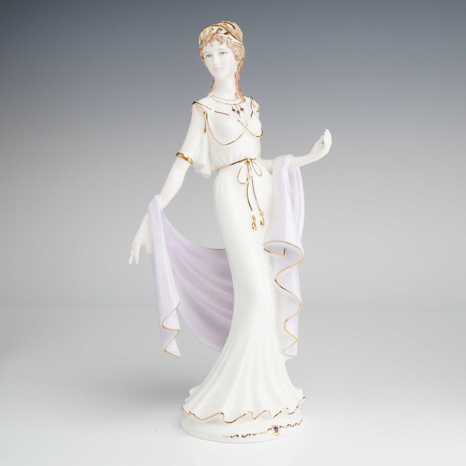 Coalport Bone China Figurine, Helen of Troy: Presented is a glazed bone china piece depicting Helen of Troy from Greek mythology. She is dressed in a white dress with a lavender shawl, accented with 22 carat gold detailing. The underside is