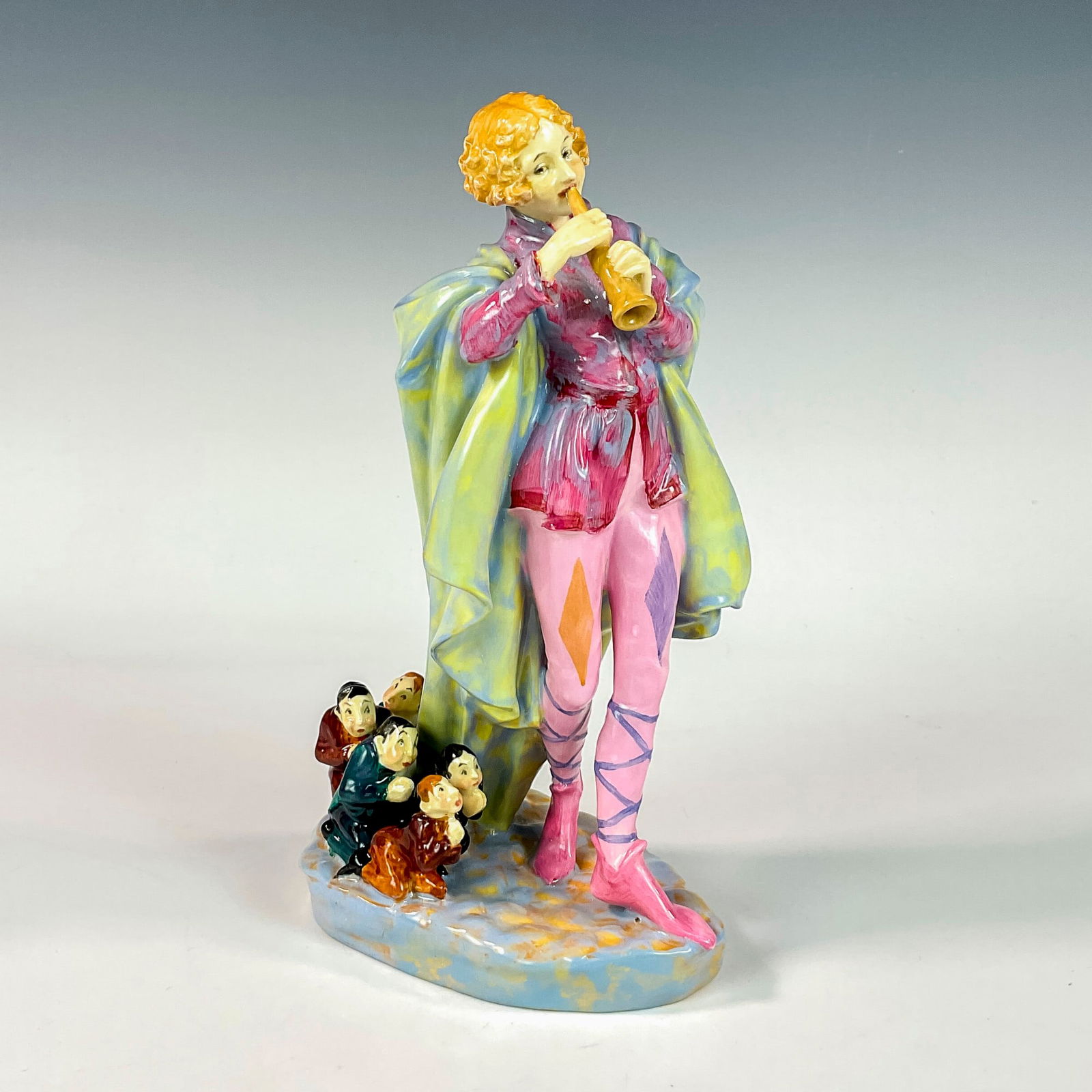 Modern Piper - HN756 - Royal Doulton Figurine: Young female Pied Piper leading the village men away. part of the Harradine Classics series. Hand written title and HN number. Royal Doulton backstamp. ArtistLeslie Harradine Dimensions8.5"H Date