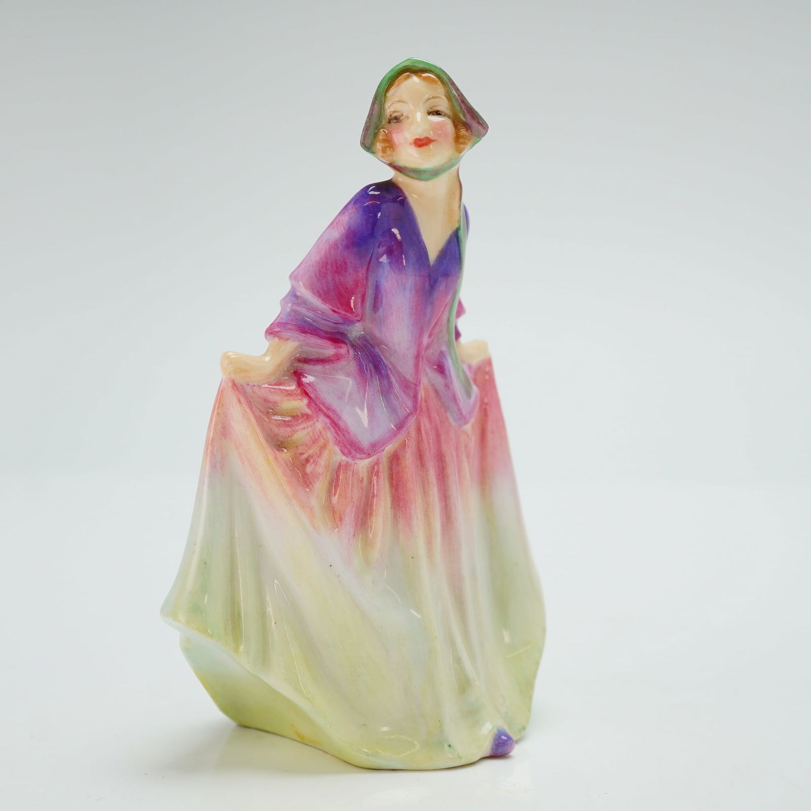 Royal Doulton Miniature Figurine, Sweet Anne M5: Hand painted figure of a woman curtsying. Lavender and green coloration. Royal Doulton backstamp. ArtistLeslie Harradine Dimensions4.25"H Date or Era1932 - 1945 Manufacturer or BrandRoyal Doult