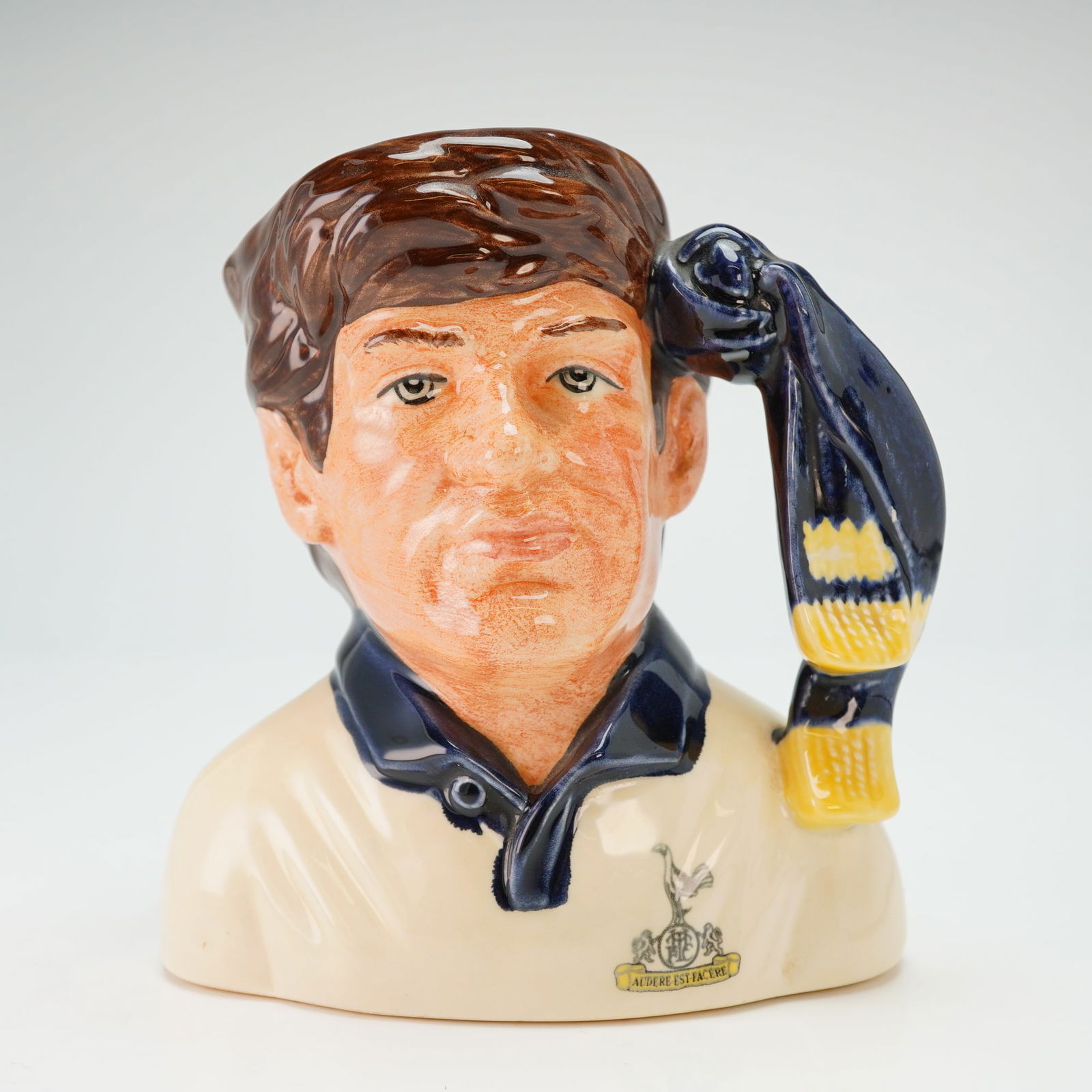 Royal Doulton Rare Character Jug, Tottenham Hotspur D6960: Tottenham Hotspur Football Club. Designed by Stanley J. Taylor as part of The Football Supporters series. This specific iteration displays a deviation from the standard production model; while the fig