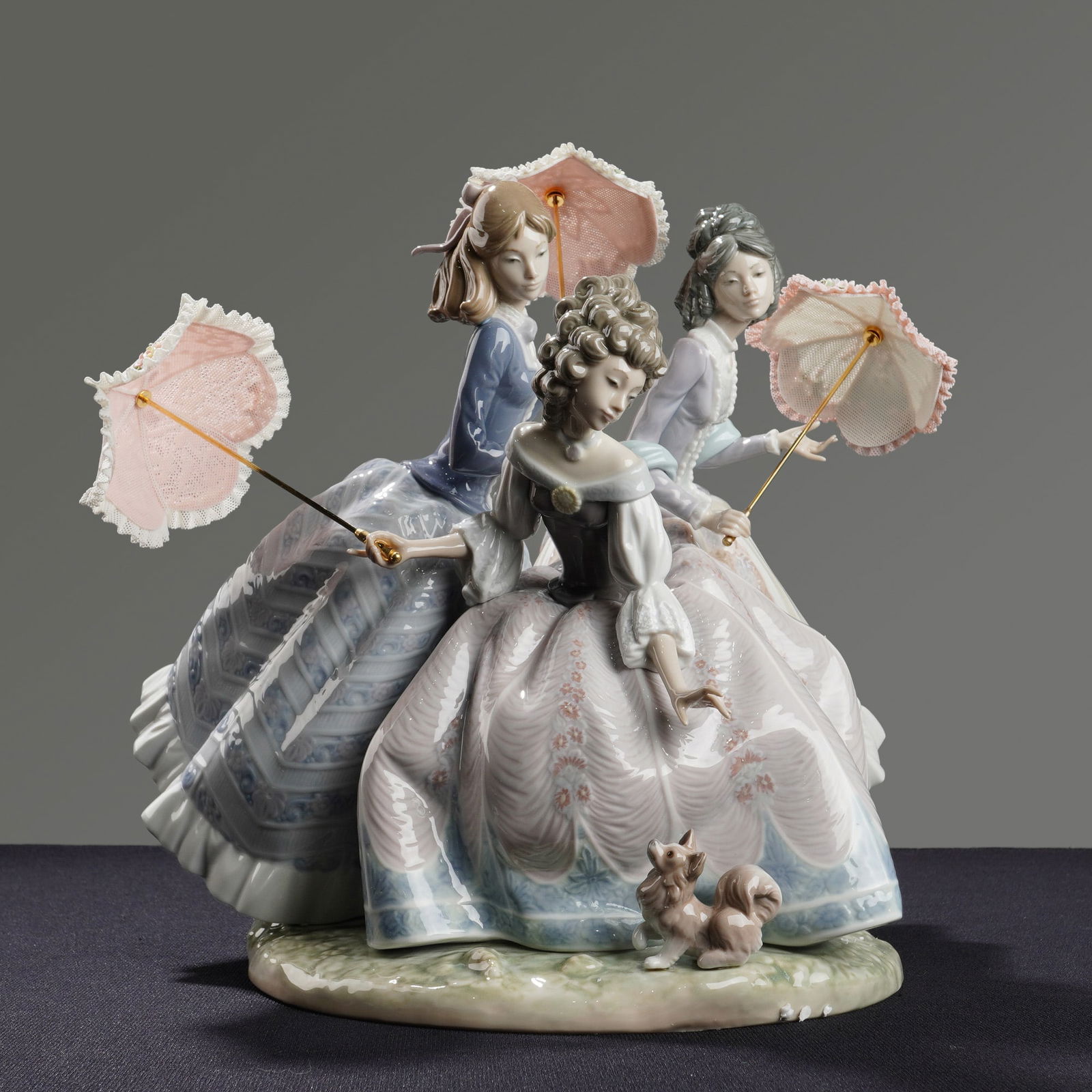 Lladro Limited Edition Porcelain Sculpture Three Sisters Model 1492: This Lladro limited edition glazed porcelain sculpture is titled Three Sisters, model number 1492. The group depicts three women in 19th-century period gowns positioned on a grassy mound base accompan