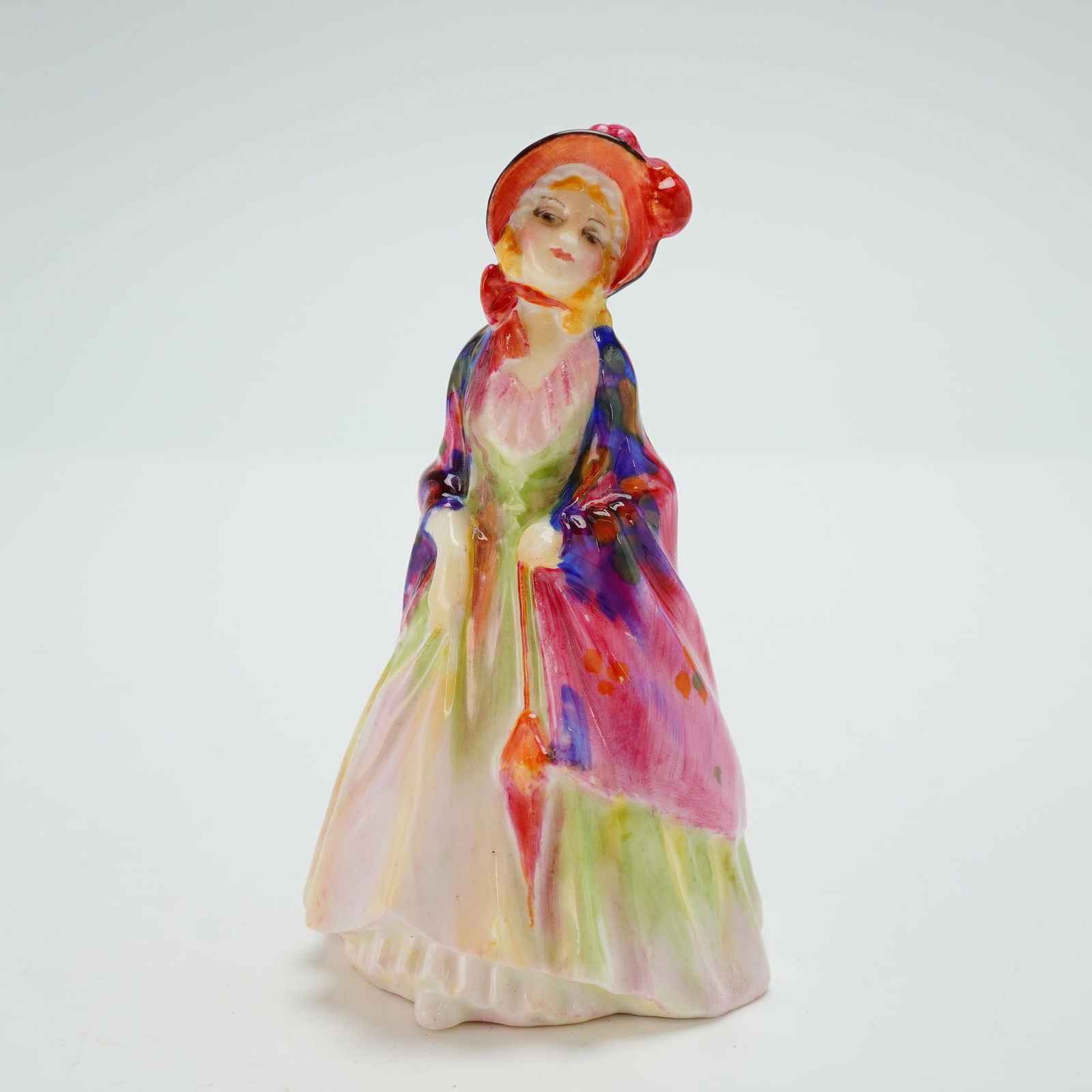 Royal Doulton Miniature Figurine, Paisley Shawl M4: Part of the Miniature series. Hand painted figure of a woman in a ruffled dress. Purple, pink and green coloration. Royal Doulton backstamp. Dimensions4.25"H Manufacturer or BrandRoyal Doulton Country