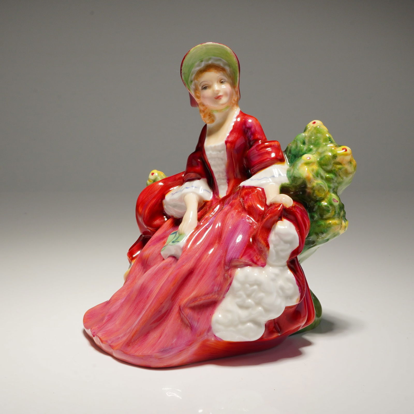 Royal Doulton Figurine Lydia HN 1908: A single red and green Royal Doulton Figurine LYDIA hn1908 ceramic figure marked "H. N. 1908," "COPR 1939," and "DOULTON & CO. LIMITED." Dimensions: 4.25"L x 4.00"W x 4.75"H Weight: 9.00oz