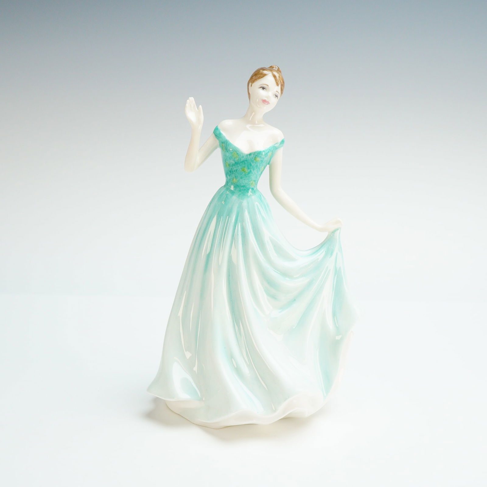 Royal Doulton Figurine, Chloe HN4456: A Royal Doulton from the Classics collection. This hand-decorated figure was modeled by Nada M. Pedley and depicts a woman in a flowing, pale seafoam green gown with a darker green floral bodice. The