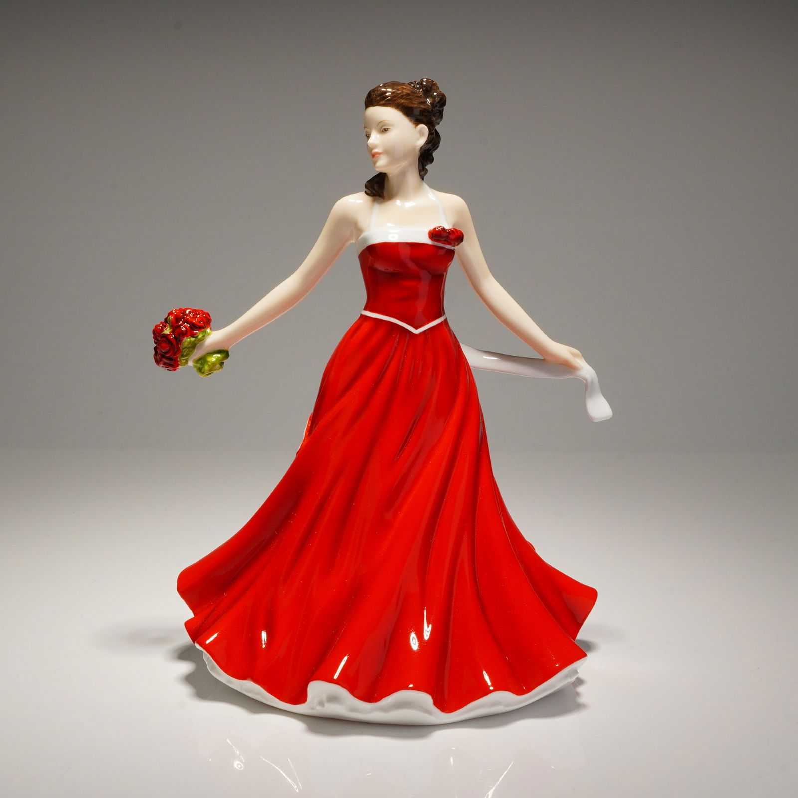 Royal Doulton Flower of the Month June-Rose Love Figurine HN 5505: Royal Doulton Flower of the Month petite bone china figurine titled June-Rose Love, model number HN 5505. This hand-made and hand-decorated object is constructed of bone china and depicts a female fig