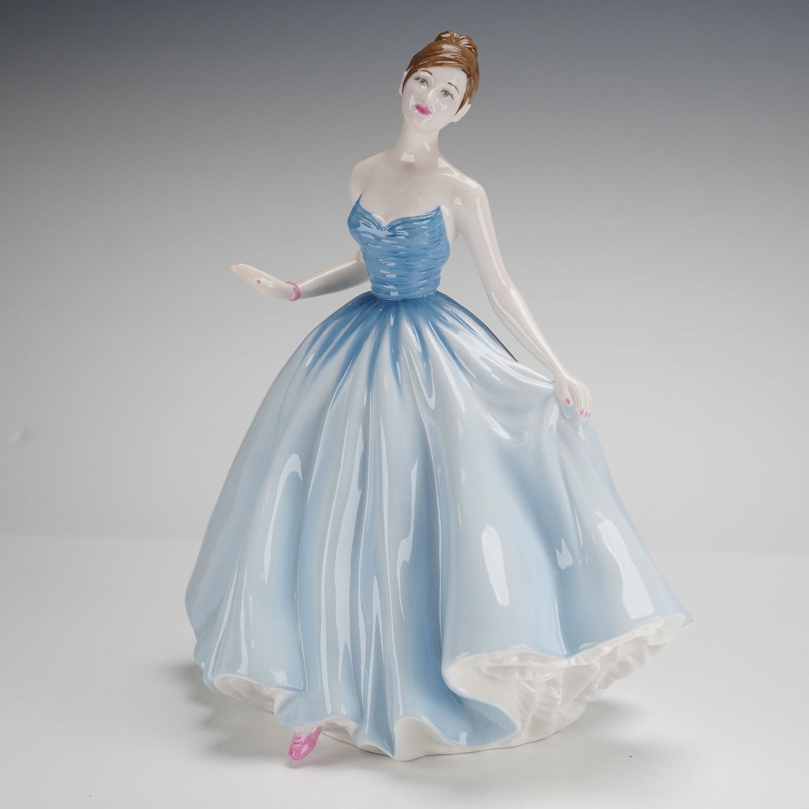 Royal Doulton Pretty Ladies Sweet Innocence Figurine HN 4740: A Royal Doulton bone china figurine titled Sweet Innocence, model HN 4740, from the Pretty Ladies series. Designed by Carolyn Wood and dated 2005, this hand-decorated piece depicts a woman in a flowin