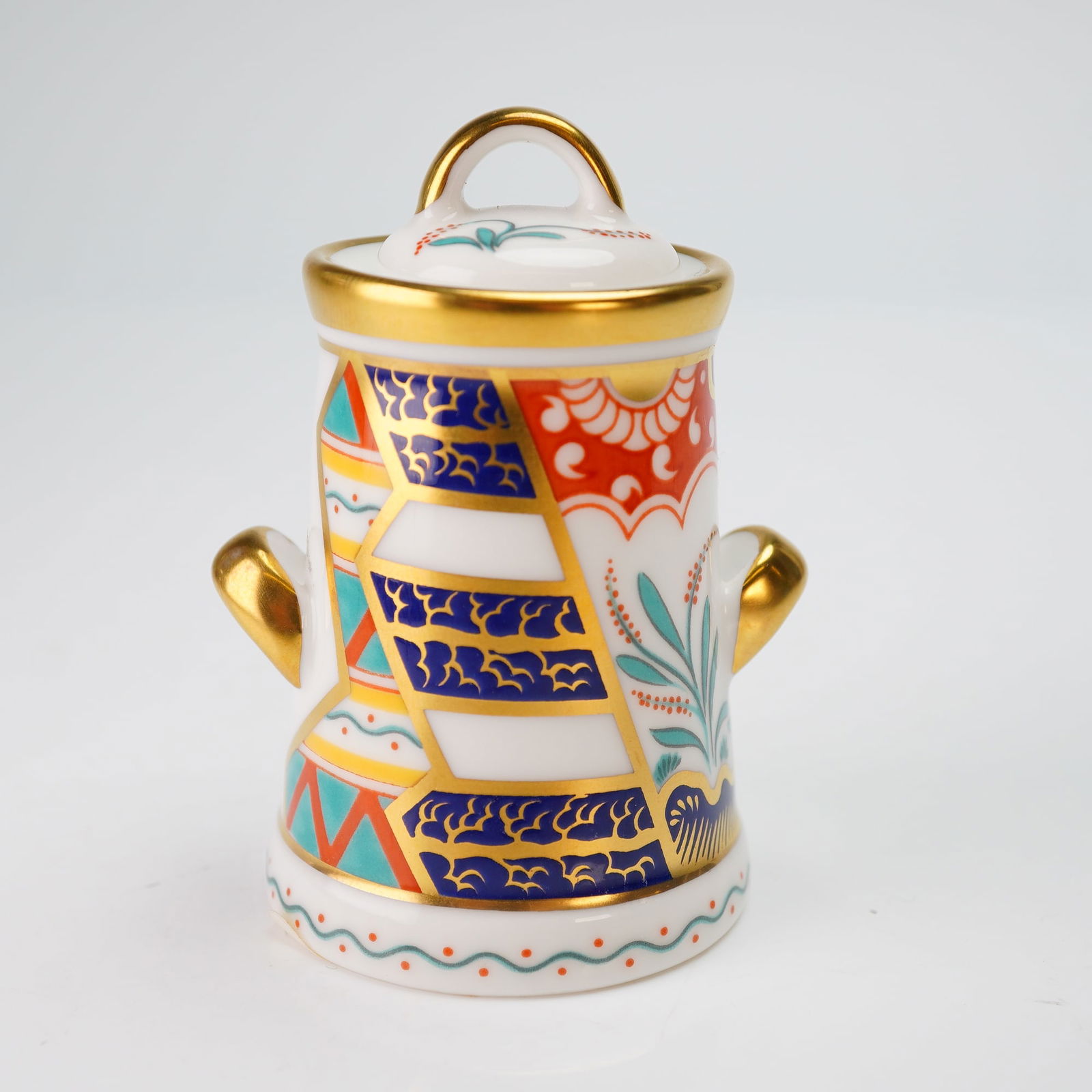 Royal Crown Derby Miniature Figurine, Milk Can with Lid: This Royal Crown Derby miniature milk can is constructed of fine bone china and includes its original presentation box. The exterior features a pattern of geometric, floral, and scroll motifs in