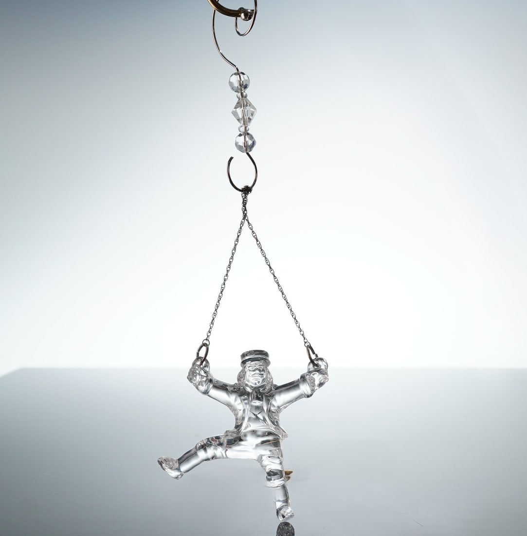 Waterford Crystal 12 Days of Christmas Ornament, Ten Lords A Leaping: The clear, polished crystal figurine depicts a male figure in a dynamic leaping pose. The item features a frosted acid-etched Waterford mark and the company's seahorse logo on the lower left leg. It