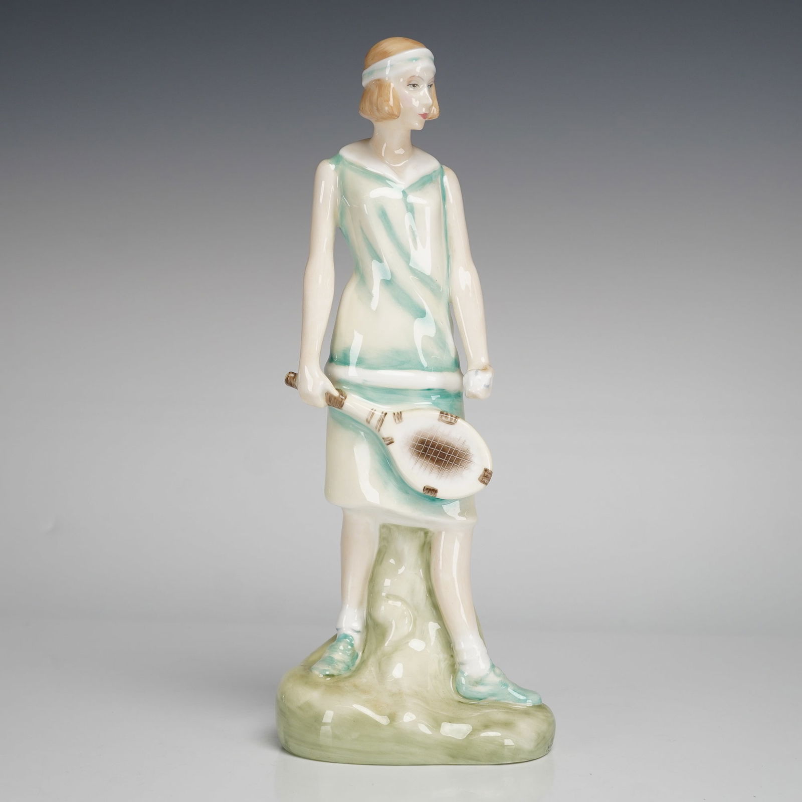 Royal Doulton Figurine Emily HN3806: A glazed bone china figurine by Royal Doulton, depicting a woman in white and teal/green outfit holding a tennis racket. Modeled by Alan Maslankowski and copyrighted in 1996. The underside features th