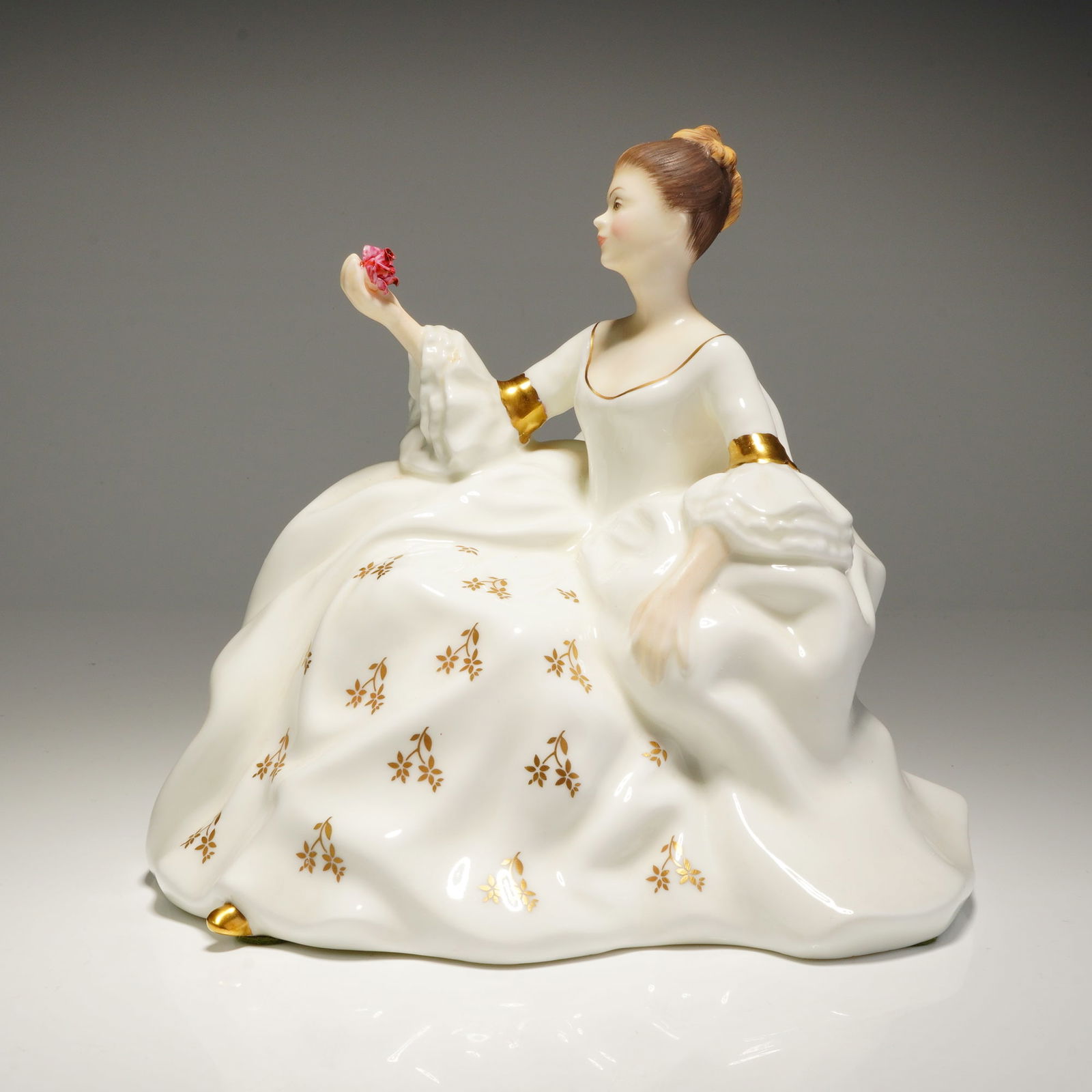 Royal Doulton Figurine My Love HN2339: A Royal Doulton porcelain figurine, My Love HN2339, depicting a woman in a white dress with gold floral accents holding a pink flower, marked COPYR. 1965. Dimensions: 7.00"L x 5.75"W x 6.25"H Weight: