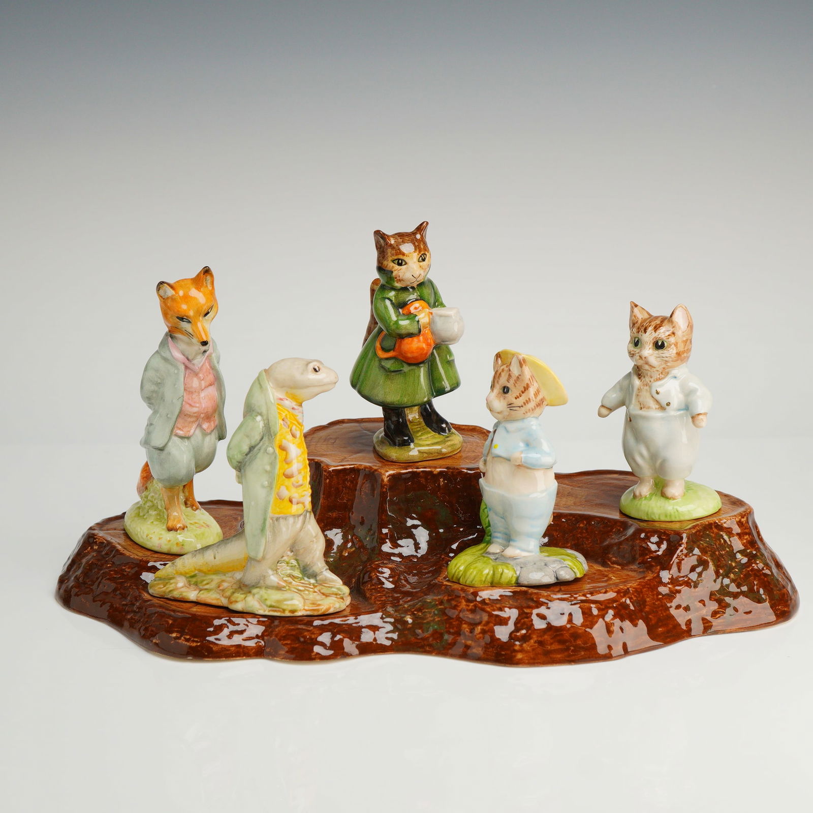 A Collection of Six Beswick Beatrix Potter Figurines and Base (1 of 5)