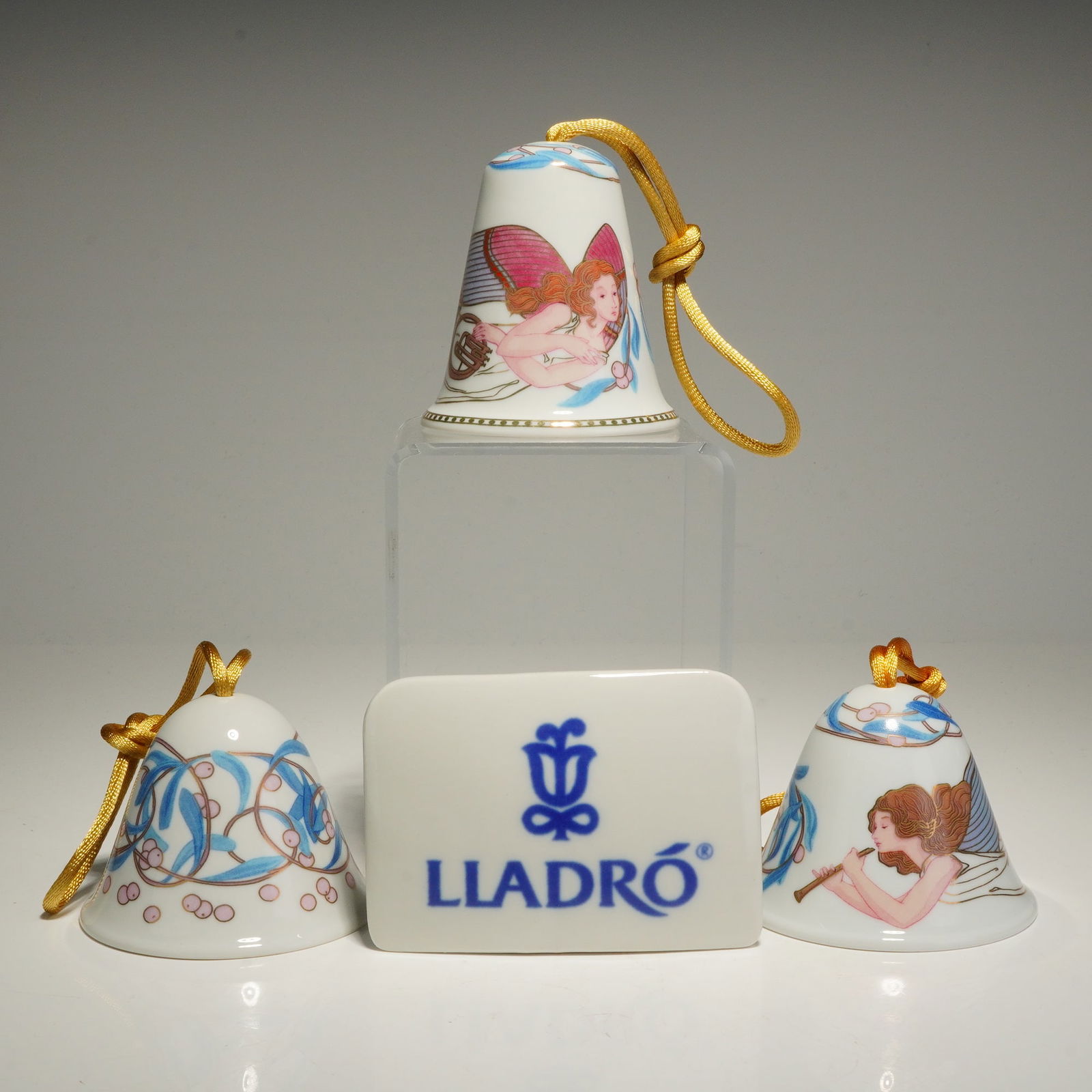 4pc Lladro Porcelain Christmas Ornaments and Plaque: A collection of Lladro porcelain Christmas ornaments and accessories, including three bell ornaments, and a branded porcelain name plaque. Celestial Music Bell (1008076) and Angelic Melody Bell (10080
