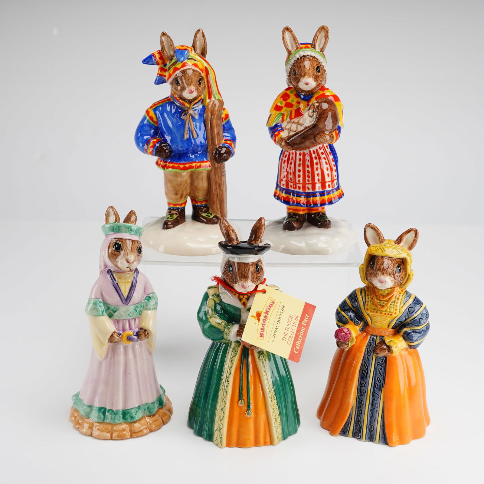 6pc Royal Doulton Bunnykins Figurines Anne of Cleves Maid Marion: A 6pc collection of Royal Doulton Bunnykins ceramic figurines featuring hand-painted anthropomorphic rabbits in various historical and regional costumes. This group includes Anne of Cleves DB309 and C