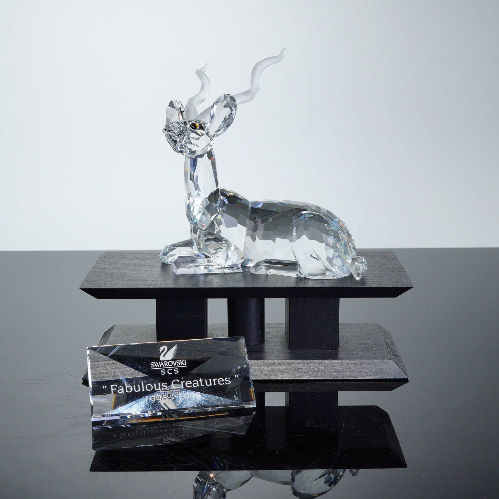Swarovski Crystal 1994 Annual Edition Figurine, Kudu with Plaque and Base: A Swarovski Crystal Society SCS 1994 Annual Edition Kudu figurine from the Inspiration Africa series. The figurine is crafted from faceted clear lead crystal with frosted spiraling horns and small ins