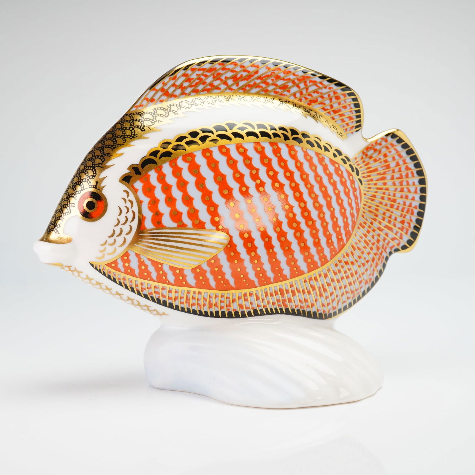 Royal Crown Derby Paperweight, Gourami Tropical Fish: The figure is modeled on a white stylized wave base and decorated in an Imari-style palette consisting of orange-red stripes and scales with black accents. The piece features 22kt gold gilding. The un