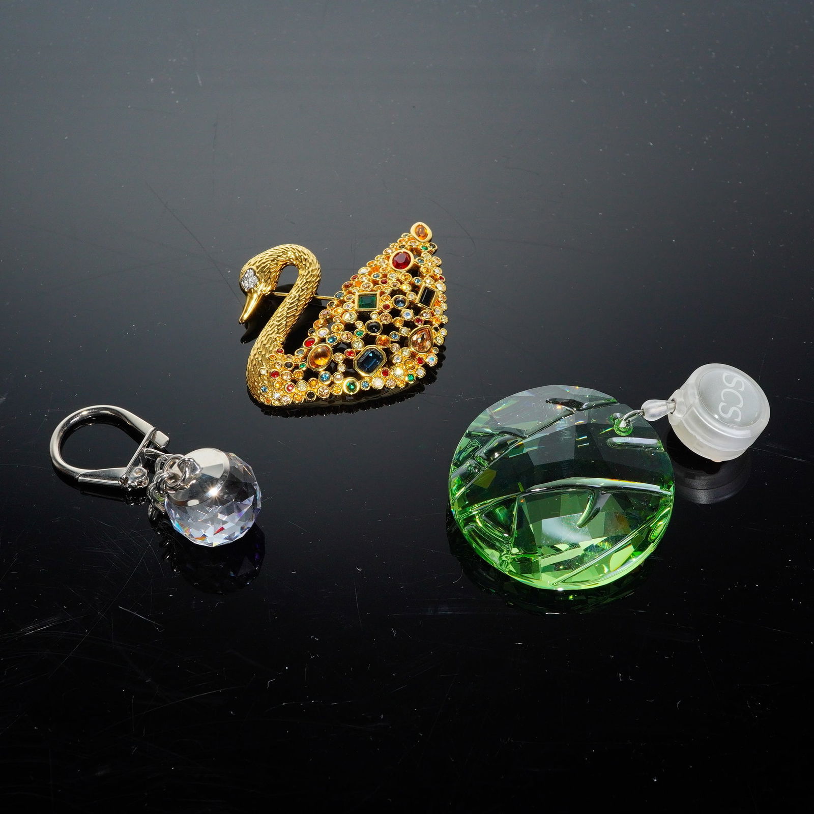 3pc Swarovski Crystal Society Accessories: A trio of Swarovski Crystal Society SCS accessories and collectibles. The collection features a gold-toned swan brooch, identified as a 100th Anniversary celebration piece, elaborately pave-set with m