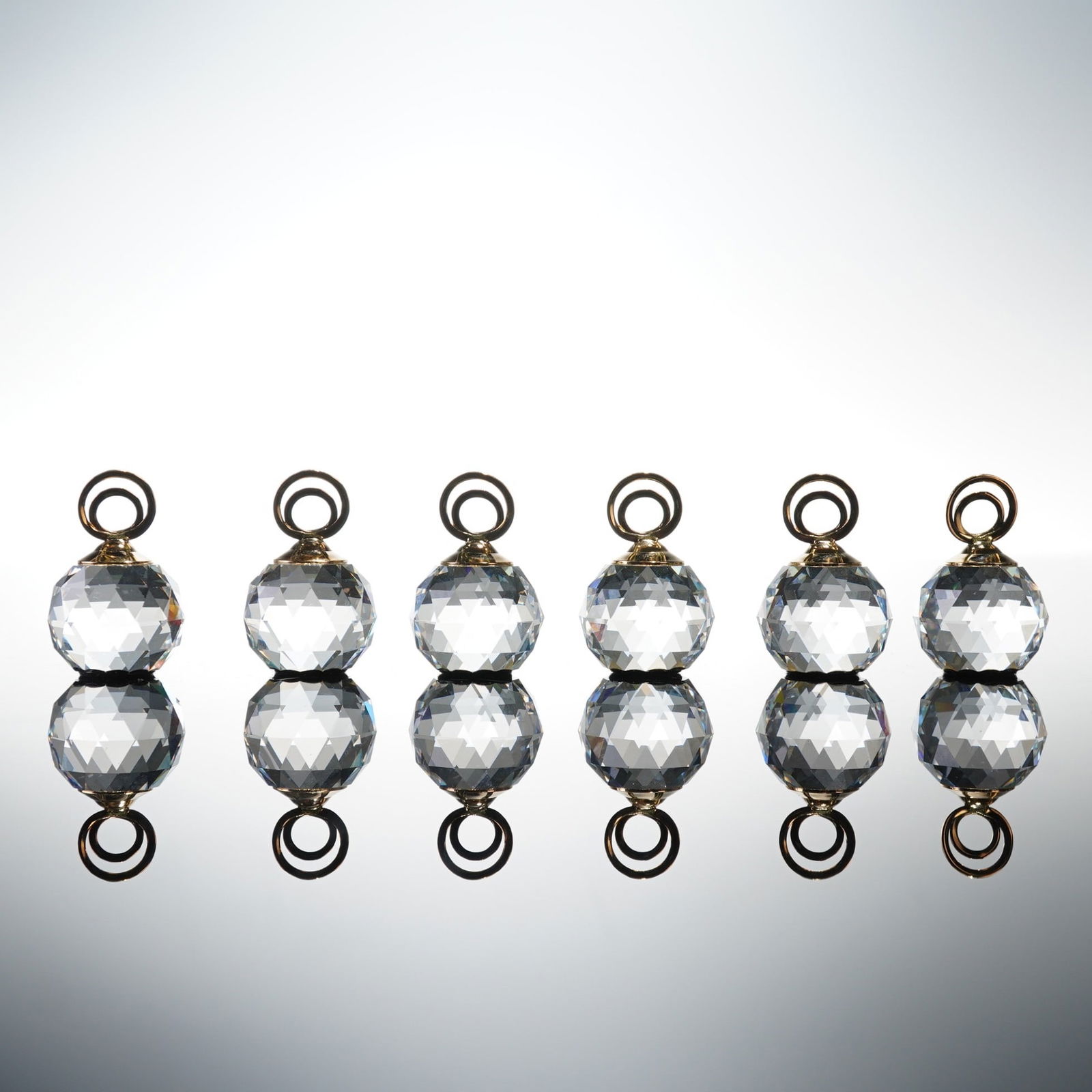 Swarovski Crystal Place Card Holders, Set of Six: This elegant set of six features brilliantly faceted crystal spheres capped with polished gold-tone rings. Designed to catch and scatter light with signature Swarovski radiance, each piece exemplifies