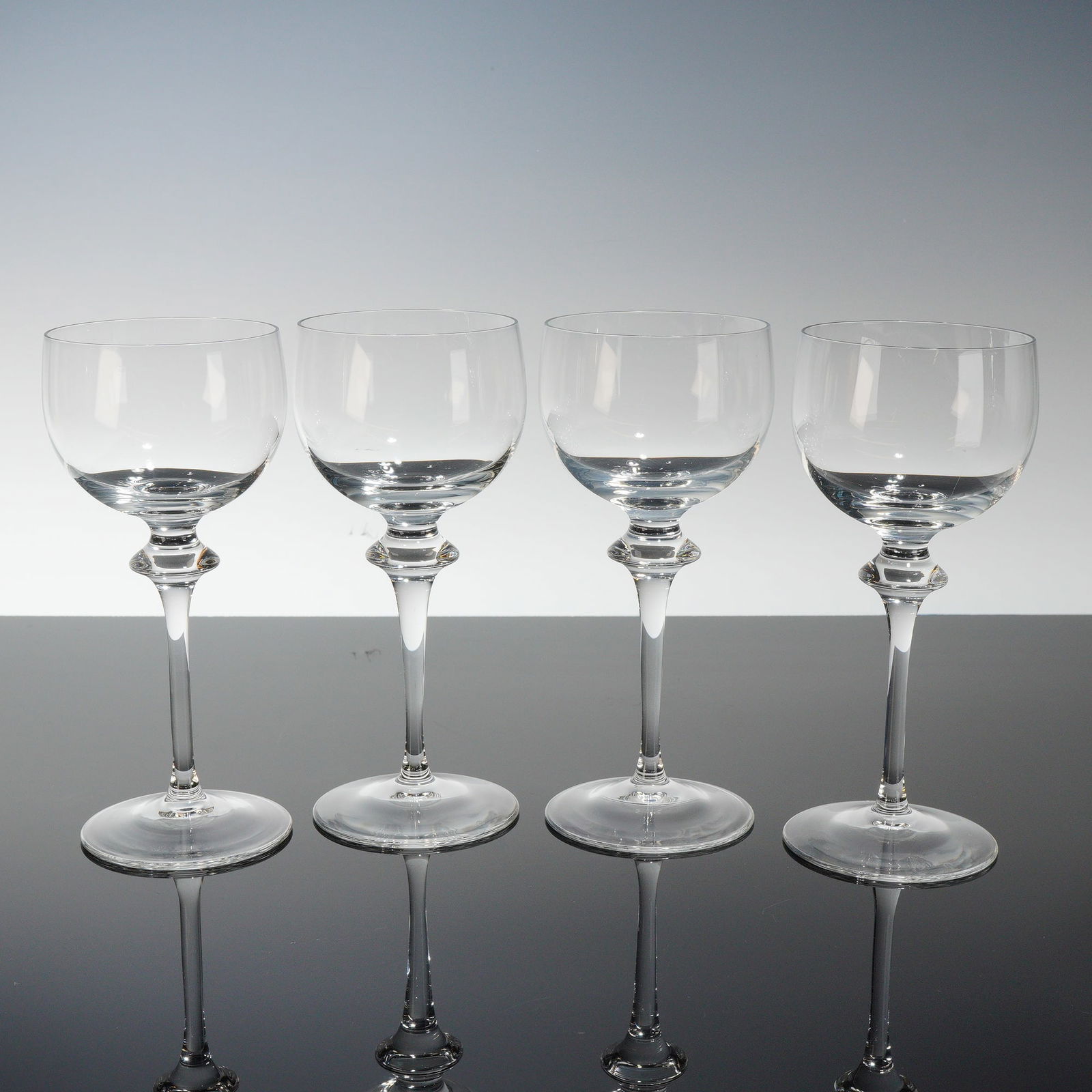 4pc Peill Clear Claret Wine Glasses, Alexa: This lot features a refined four-piece set of Peill clear claret wine glasses in the Alexa pattern, noted for their elegant form and distinctive stem design. Each glass is crafted with a gracefully pr