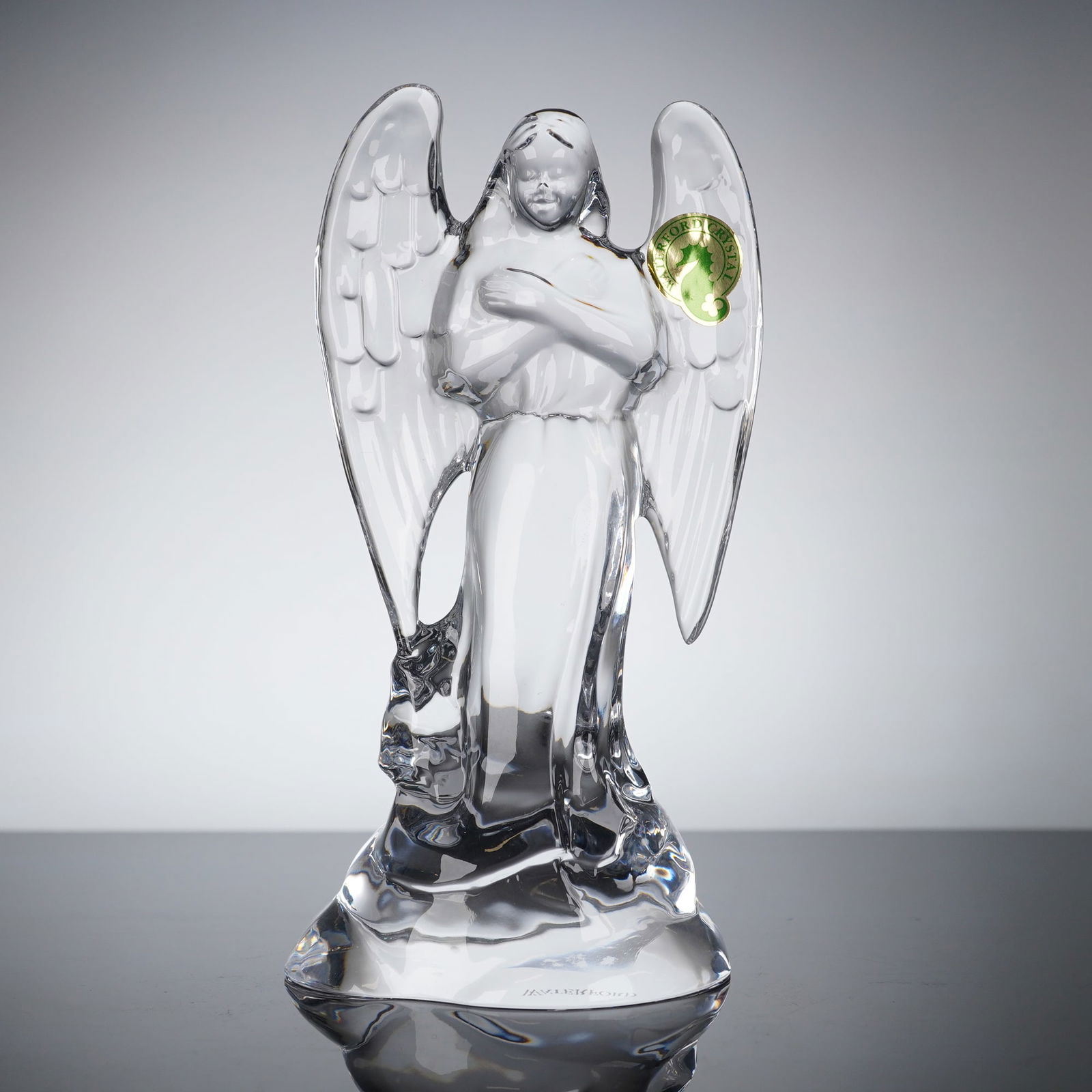 Waterford Lead Crystal Angel of Bethlehem Figurine: The figurine by Waterford "Angel of Bethlehem" is crafted from clear lead crystal and depicts a stylized angel with large feathered wings and flowing robes, standing with hands clasped across the ches