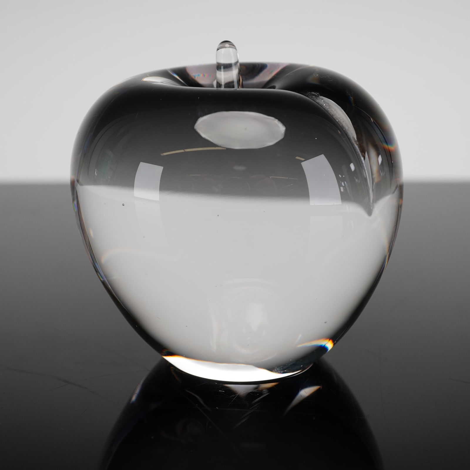 Wedgwood Crystal Apple Paperweight: Hand-formed in clear lead crystal with a polished finish, the piece features a smooth, life-like apple form as part of Steuben's distinguished line of decorative crystal objects. A timeless symbol of