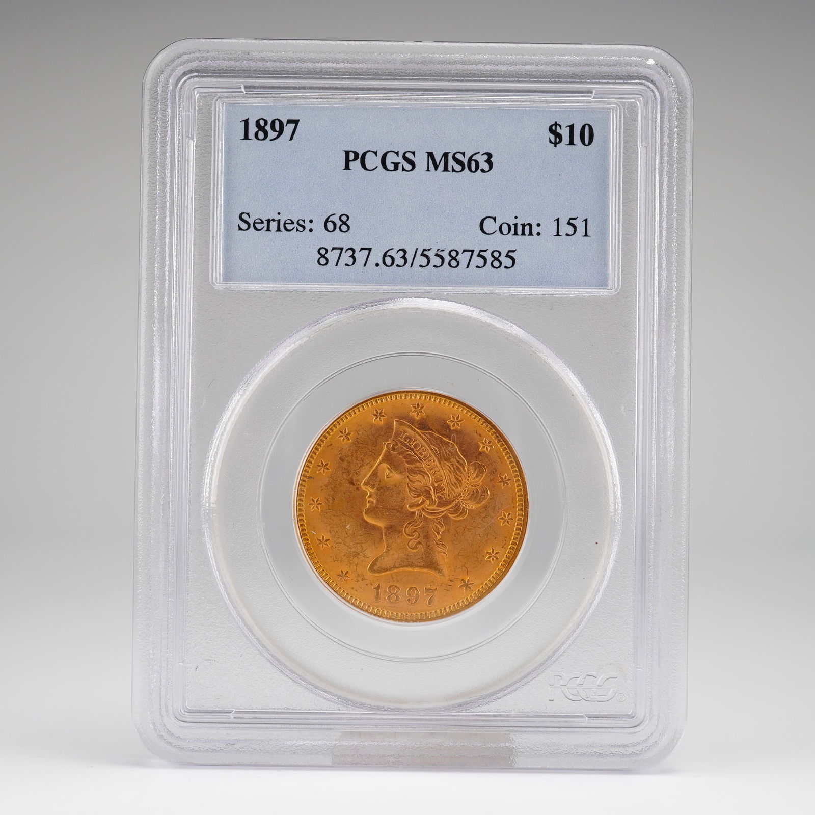 1897 $10 Liberty Head Gold Coin, PCGS MS63: Graded MS63 by PCGS. The obverse, designed by Christian Gobrecht, features Liberty wearing a coronet, facing left, surrounded by 13 stars with the date below. The reverse, also by Gobrecht, displays