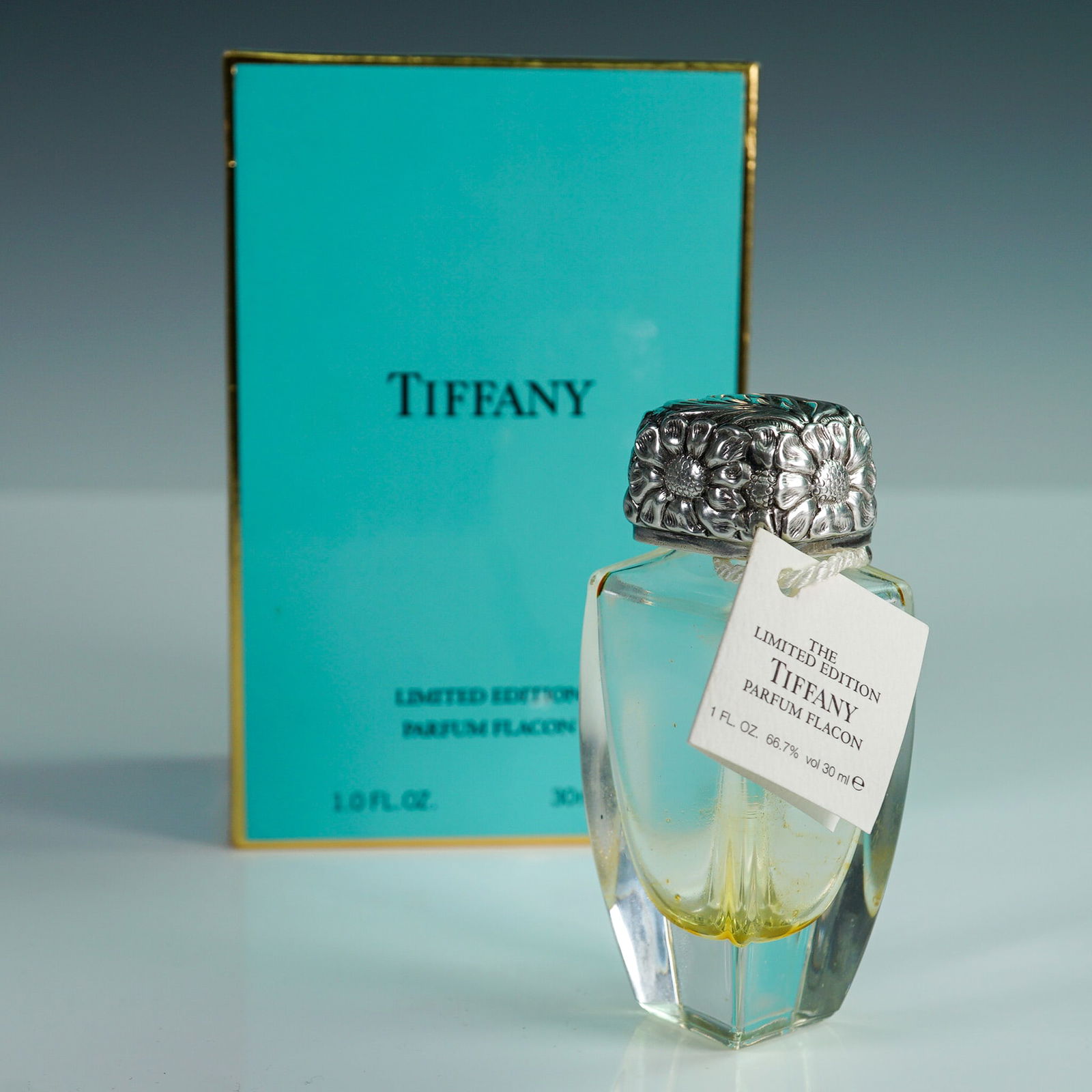 Tiffany & Co Limited Edition Parfum Flacon Bottle with Box: Tiffany & Co. limited edition of only 1000 parfum flacon bottle, 1 fl. oz. (30 ml) size, with sterling silver cap, presented in its original Tiffany blue box with gold trim. The faceted glass bottle