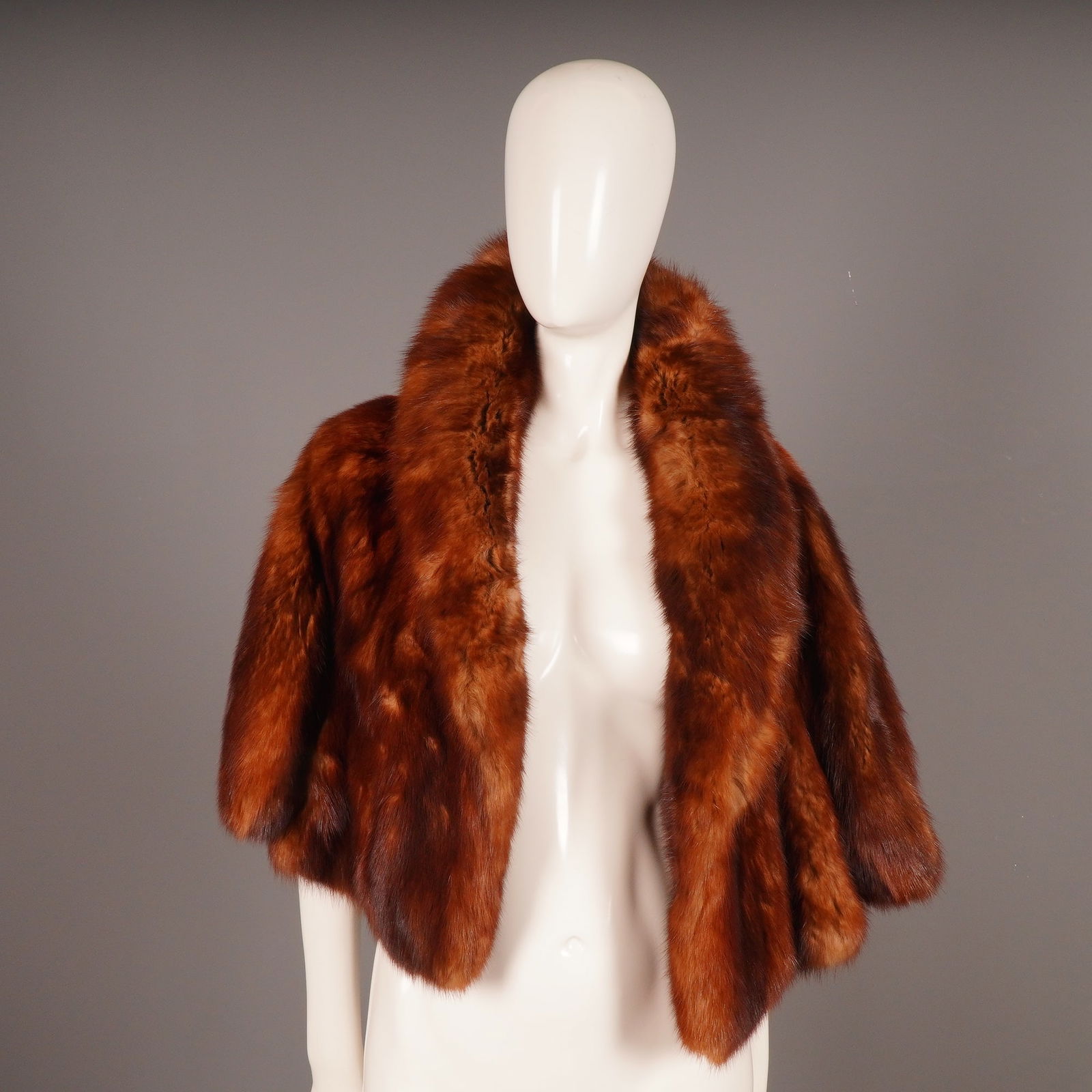 Vintage Brown Mink Fur Bolero Jacket: A vintage fur bolero jacket or short cape, constructed from deep russet-brown pelts, likely mink or dyed sable or fox, consistent with mid-century styles. The garment features vertically stitched pelt