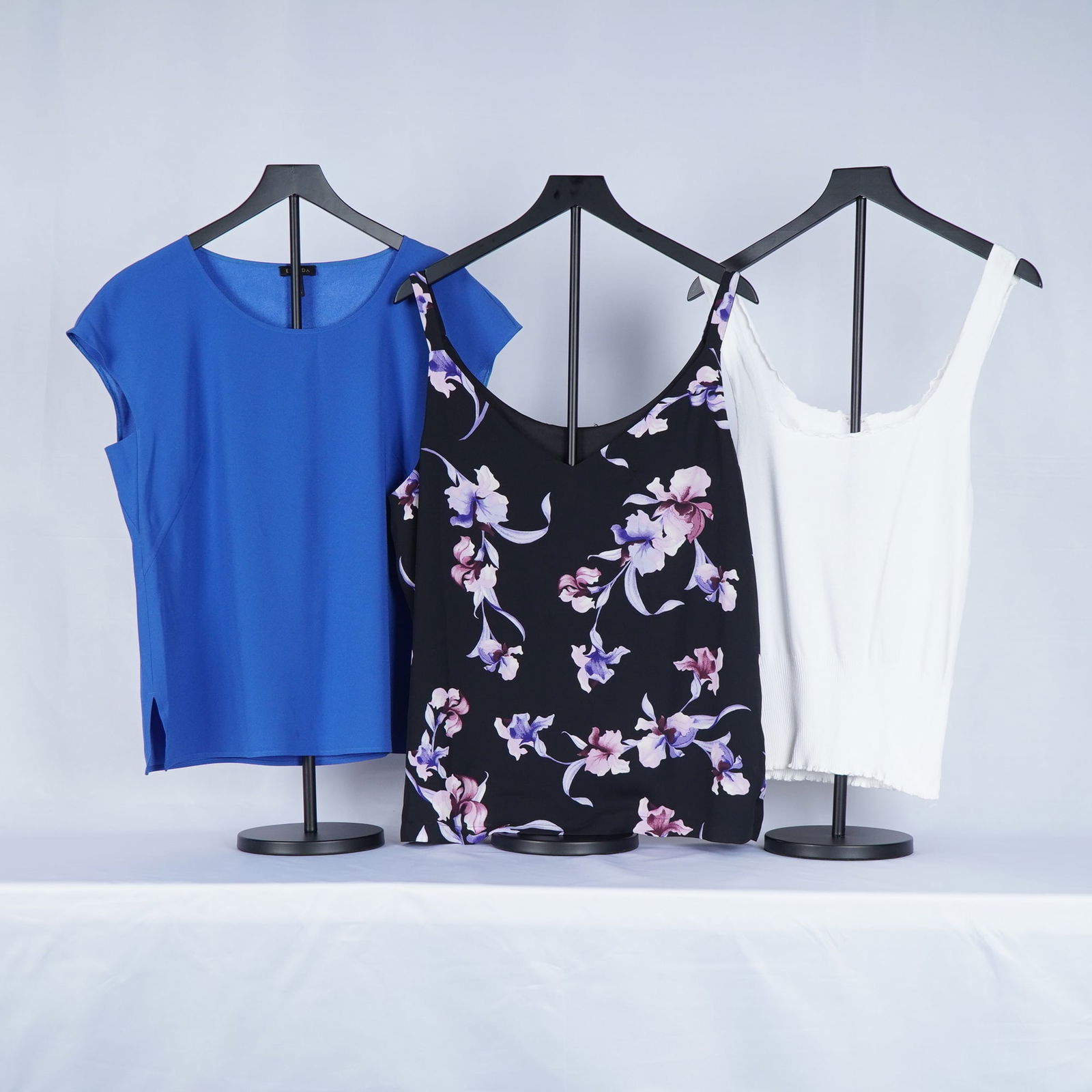 3pc Escada Short and Sleeveless Silk and Knit Blouses: Tops in a mix of silk and fine knit fabrics for layering and warm-weather wear. The first piece is a cobalt blue short-sleeve blouse crafted from smooth, fluid silk with a clean, modern silhouette.