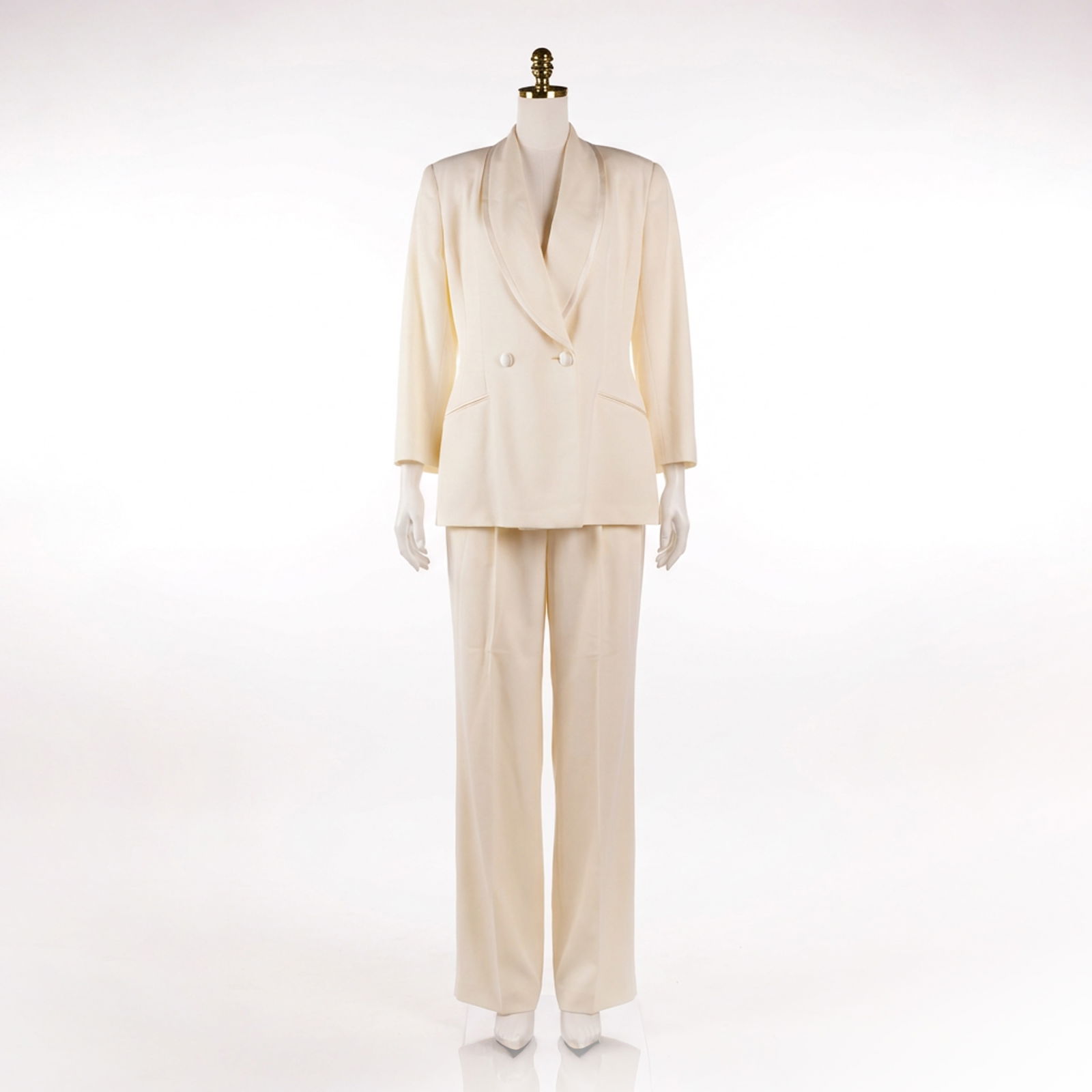 2pc Tahari Wool and Silk Off-White Double-Breasted Pantsuit: A two-piece women's ensemble by Tahari crafted from an off-white wool and silk blend fabric with a subtle texture. The set consists of a double-breasted blazer and matching trousers. The blazer