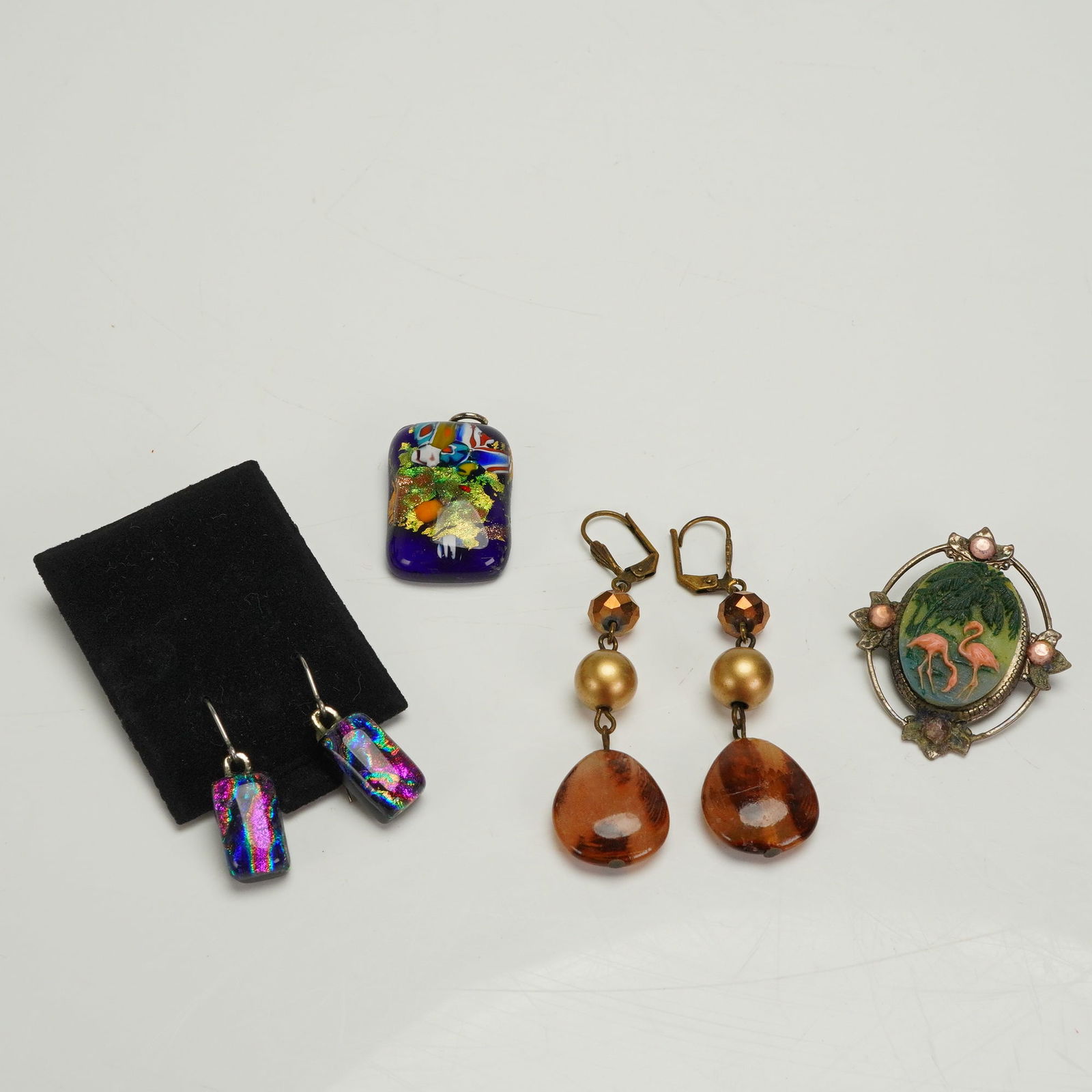 6 Costume Jewelry Pieces Dichroic Glass Beaded & Flamingo: A collection of six individual pieces of costume jewelry. The collection includes a matching dichroic fused glass pendant and a pair of coordinating dichroic glass dangle earrings. These pieces featur