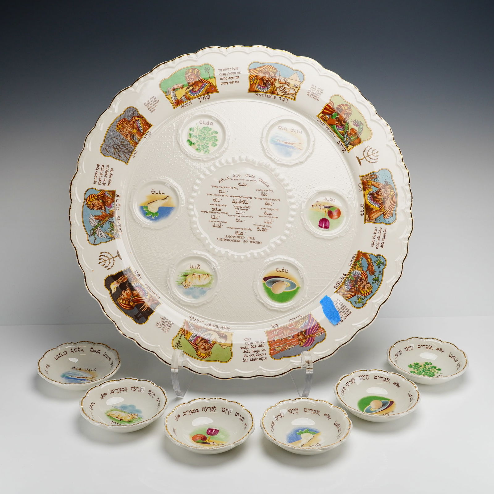 Mason's Ironstone England Passover Seder Plate Set: Collection consists of a large circular platter and six matching small bowls, all featuring a cream ground with scalloped, gold-trimmed edges. The main platter is decorated with colorful