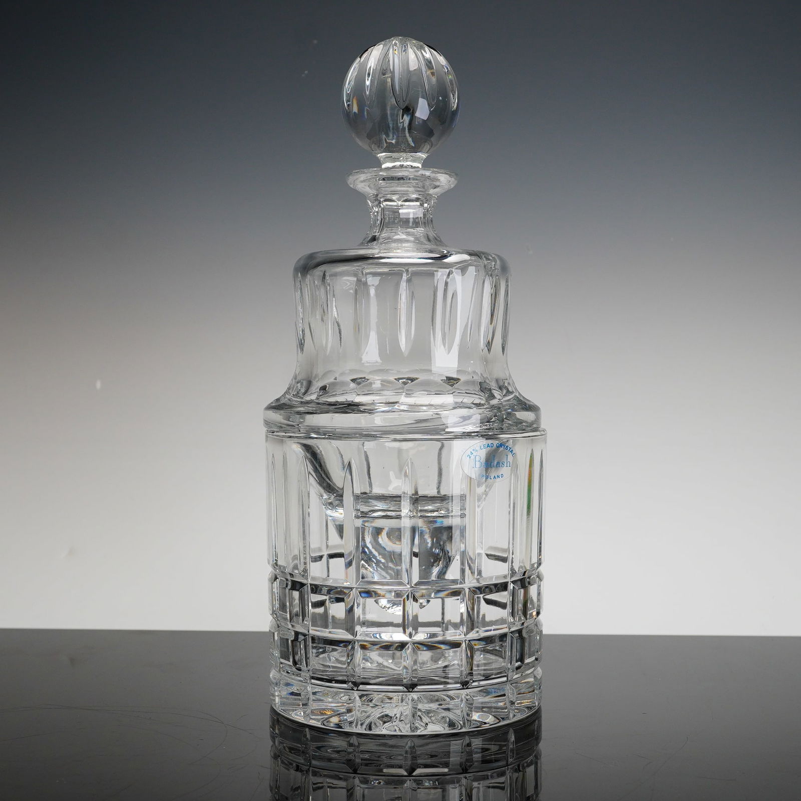 3pc Badash Crystal Decanter with Ice Bucket Bottom and Stopper: A three-piece Badash crystal decanter set manufactured in Poland. The set is constructed from 24 percent lead crystal and features a heavy cylindrical ice bucket bottom designed to hold an inner