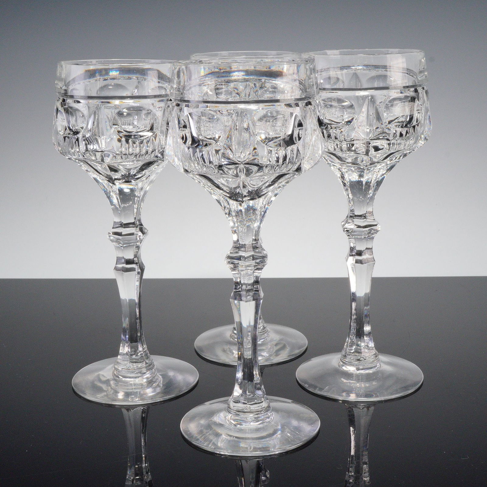 4pc Clear Cut Crystal Tall Cocktail Glasses: Set of four clear cut crystal specialty cocktail glasses featuring faceted stems and geometric banding with intricate prism detail. Finely crafted with excellent clarity, perfect for serving wine or