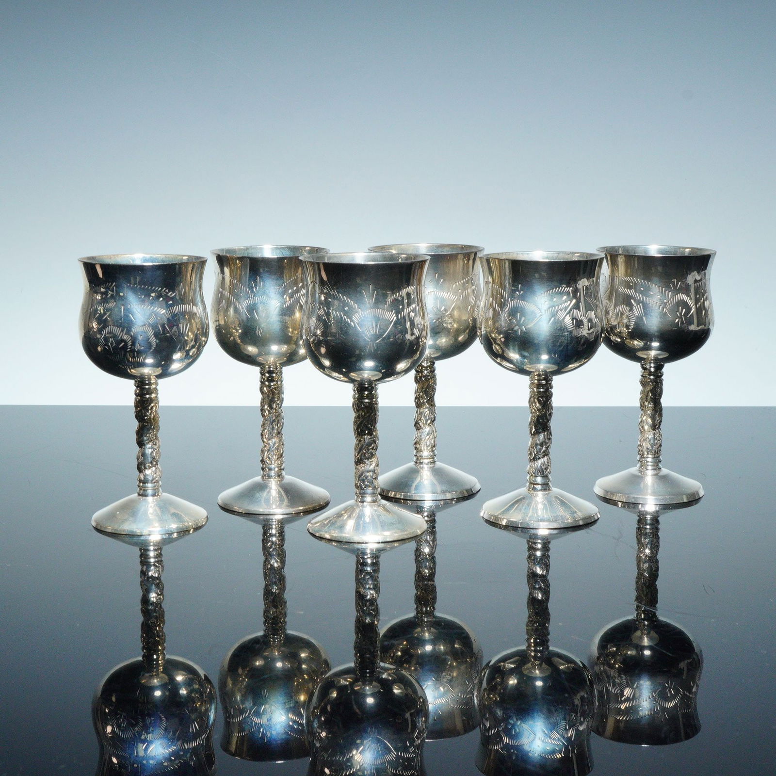 6pc Electro Plated Nickel Silver Floral Engraved Cordial Goblets: This set of six vintage cordial goblets, featuring intricate engravings and twisted stems, comes in a stylish case, making it an elegant choice for display or use. The base is mark E.P.N.S. Dimensions