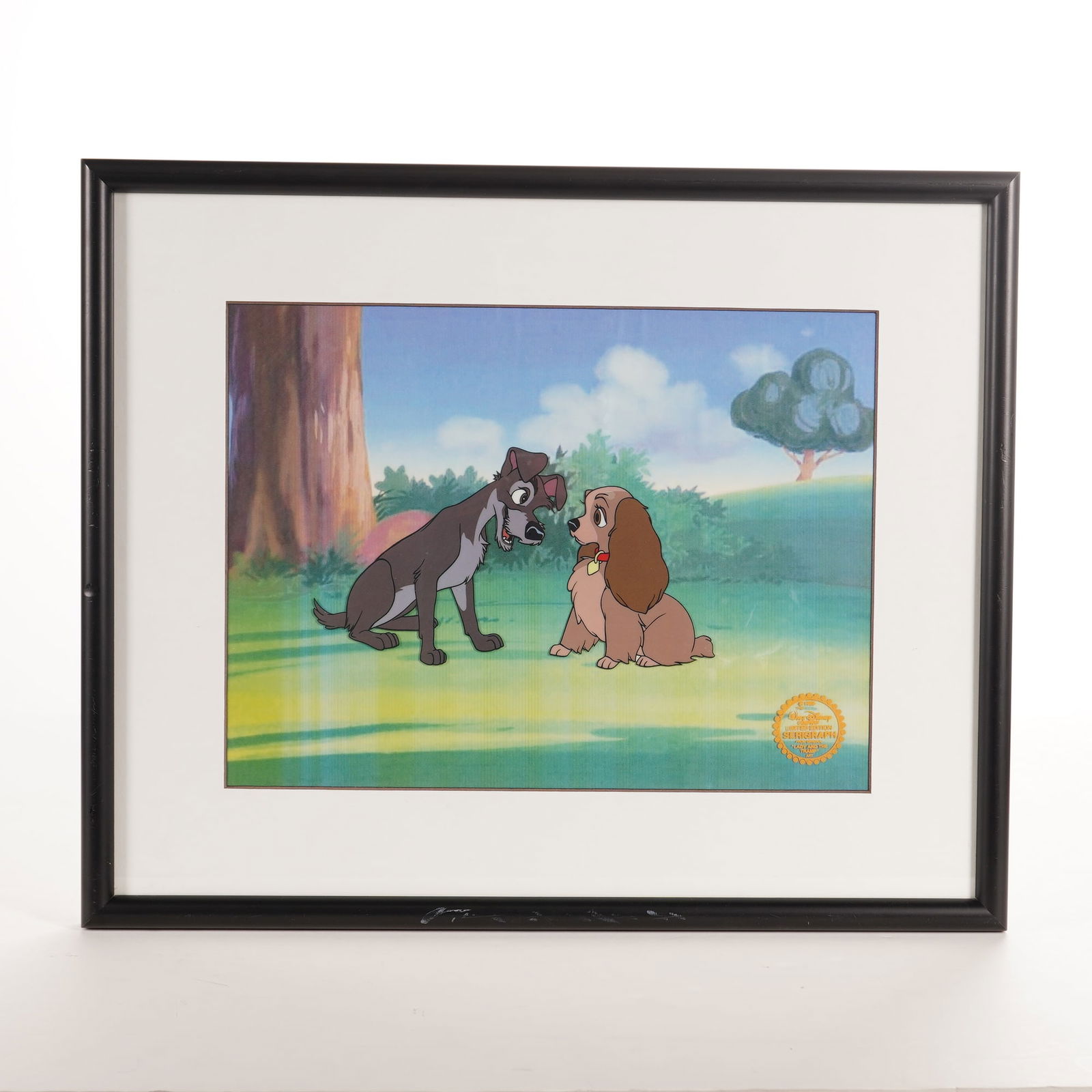 Walt Disney Limited Edition Serigraph Cel of Lady and the Tramp: This limited edition serigraph cel by the Walt Disney Company features the title characters from the 1955 animated feature film Lady and the Tramp. The artwork depicts Lady and Tramp sitting together