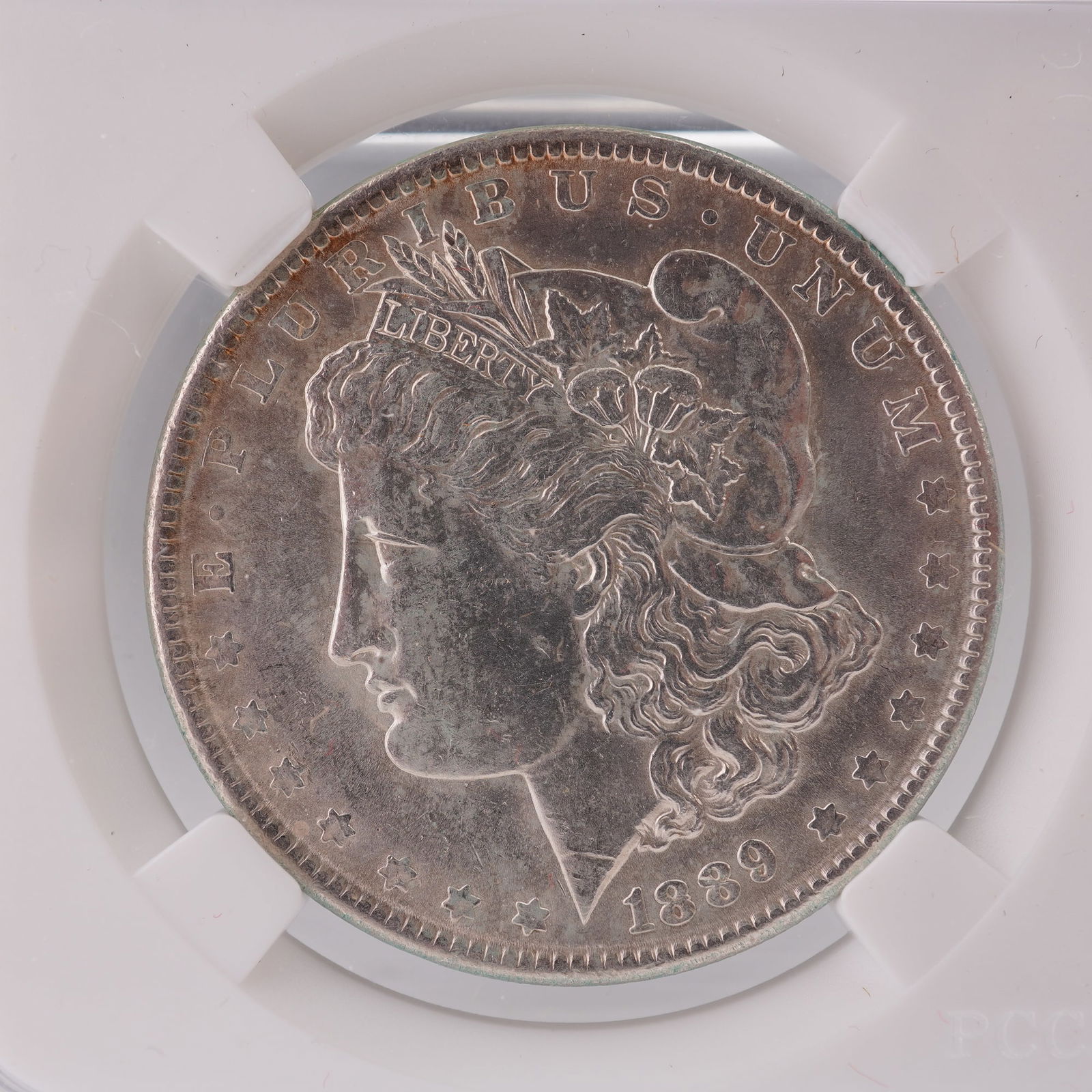 1889 (P) Morgan Silver Dollar: United States 1889 Morgan Silver Dollar designed by engraver George T. Morgan. The obverse presents a finely detailed profile portrait of Liberty wearing a Phrygian cap adorned with wheat and cotton,