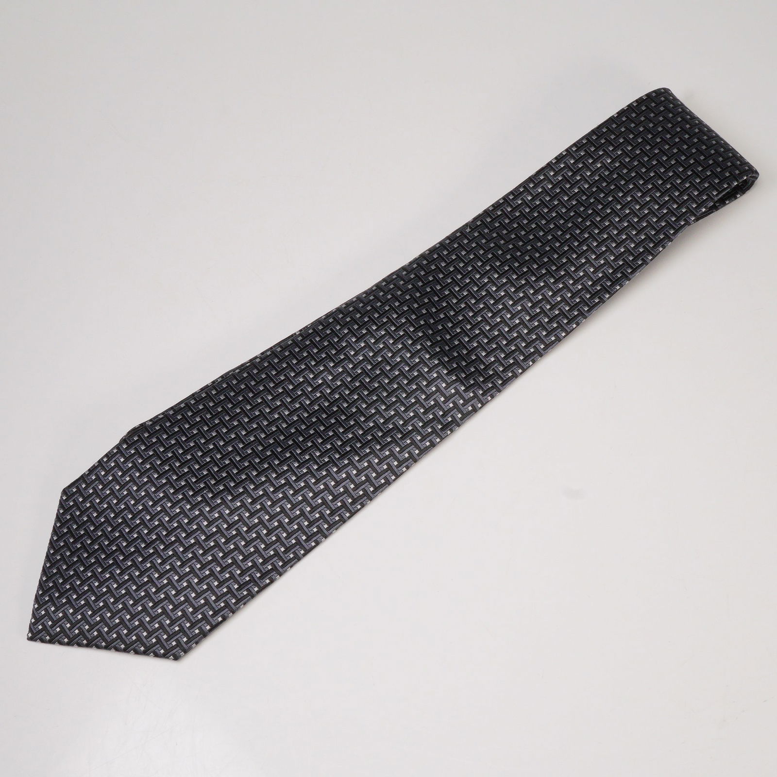 Jones New York Silk Necktie: Jones New York silk necktie featuring a woven geometric basket-weave pattern in shades of black, silver, and gray. A refined accessory with a modern design suitable for formal or professional wear. 
