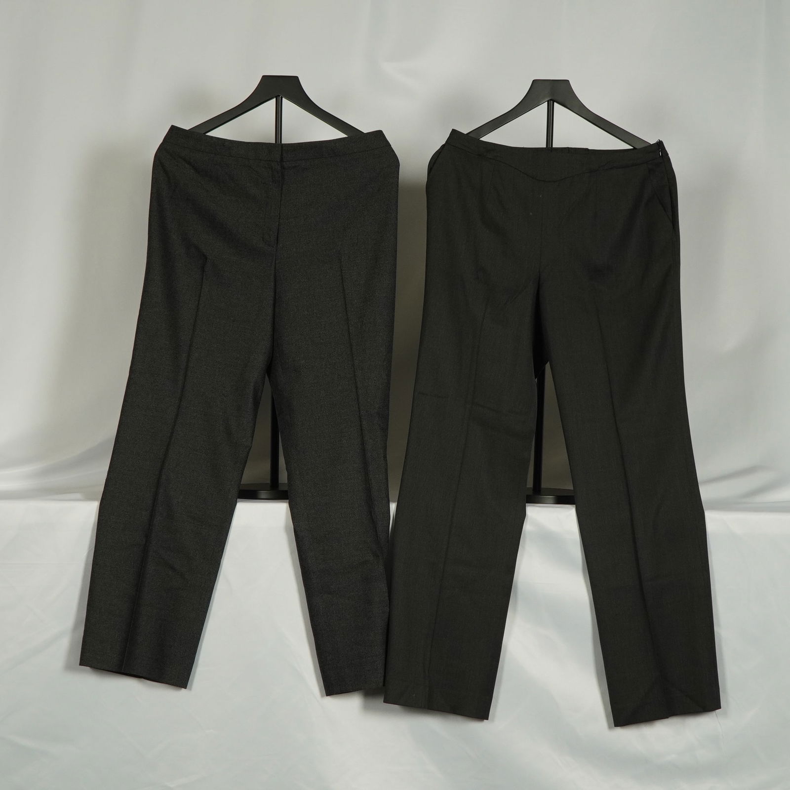 2pc Escada Charcoal Wool-Blend Trousers: A refined duo of Escada trousers in versatile charcoal tones, both crafted in a wool-blend fabric with a smooth drape and tailored silhouette. Each pair features a mid-rise waist, straight leg, and