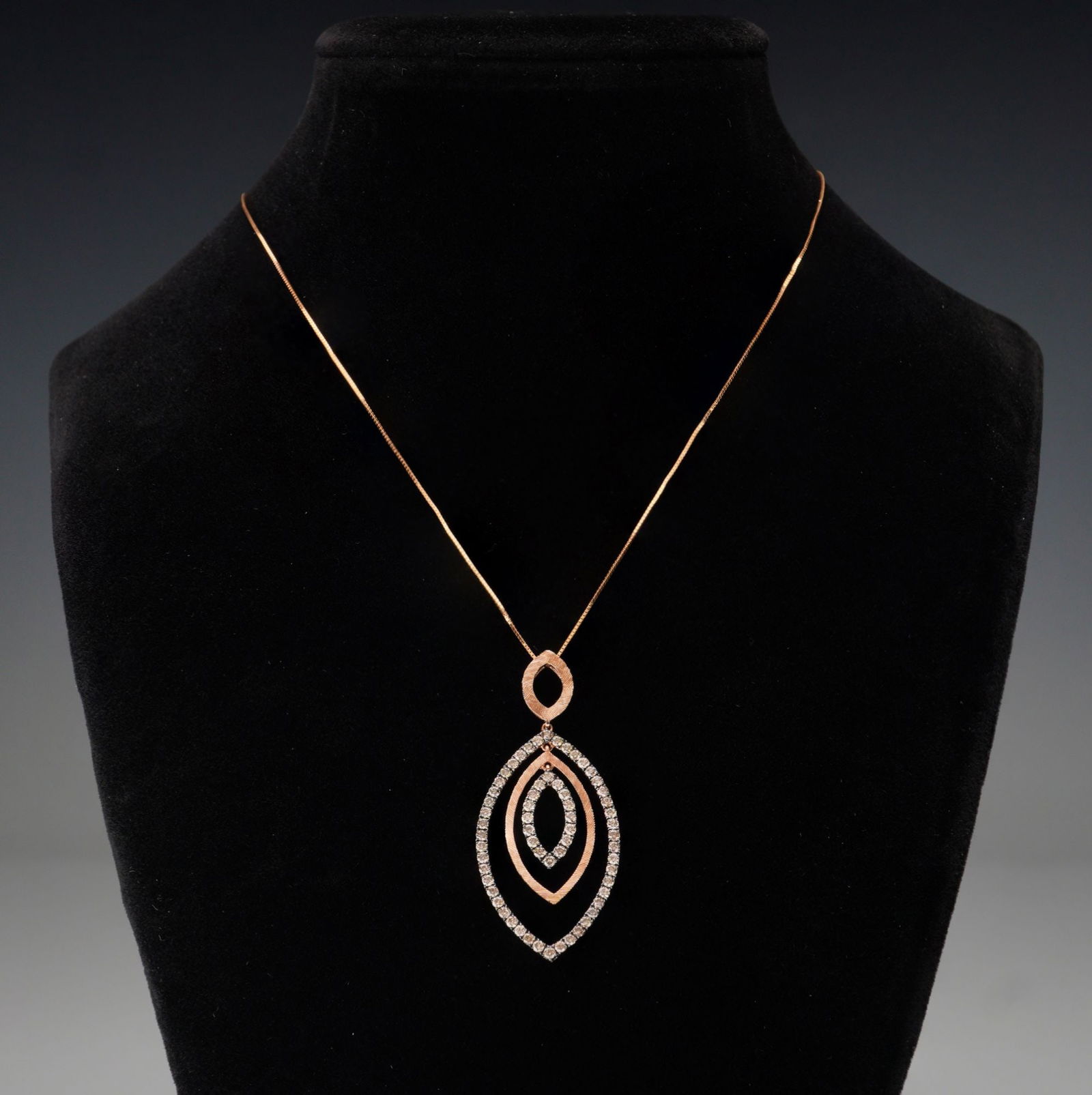 14K Rose Gold 1.02ctw Champagne Diamond Pendant Necklace: A striking 14K rose gold necklace featuring a triple marquise-shaped pendant with the outer and inner frames set with round brilliant-cut champagne diamonds totaling approximately 1.02 carat. The