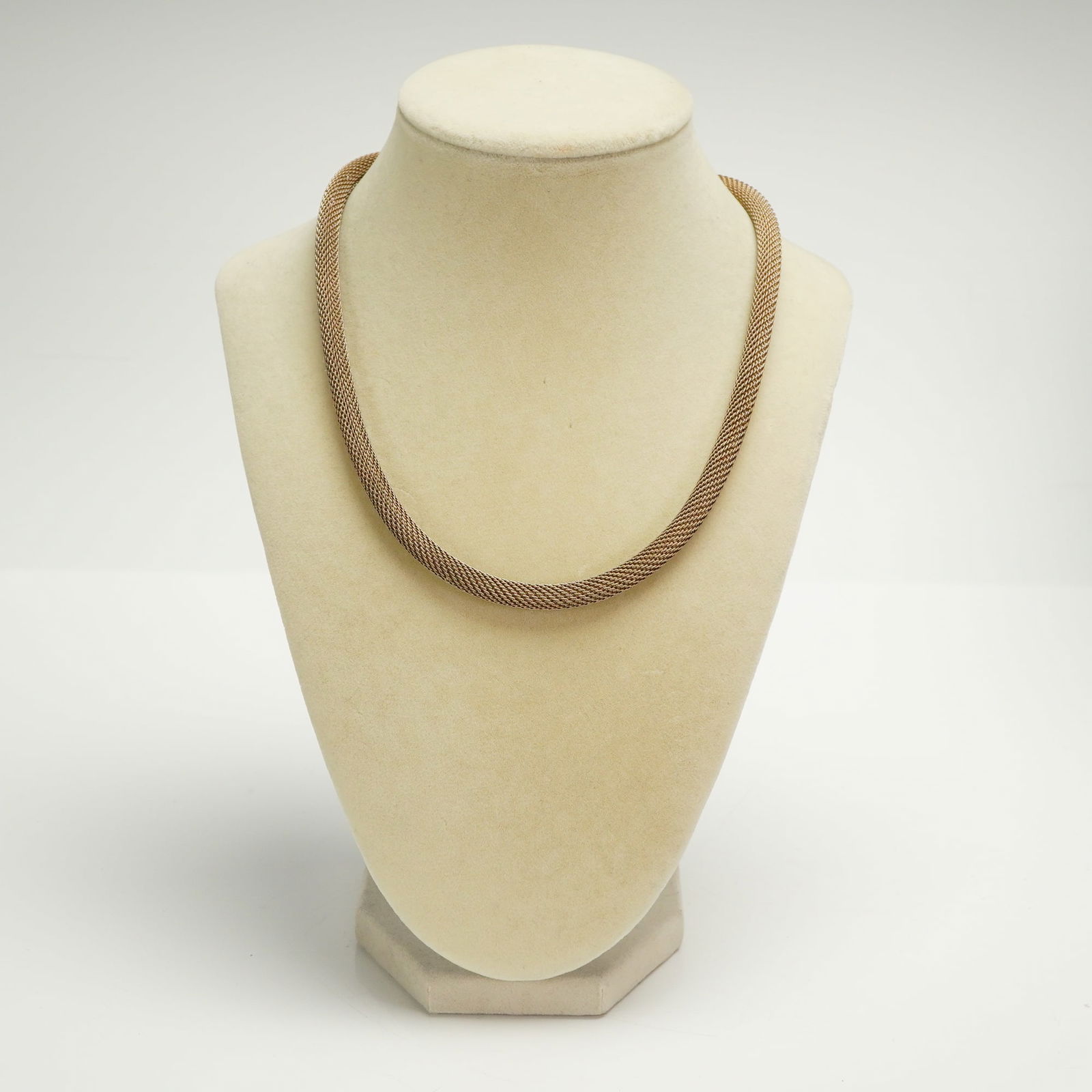 Sterling Silver and Rose Gold Tone Tubular Mesh Choker Necklace: A single sterling silver necklace constructed as a thick, tubular woven mesh chain, exhibiting a rose gold or copper-toned metallic finish. This sterling silver necklace features a cylindrical end cap