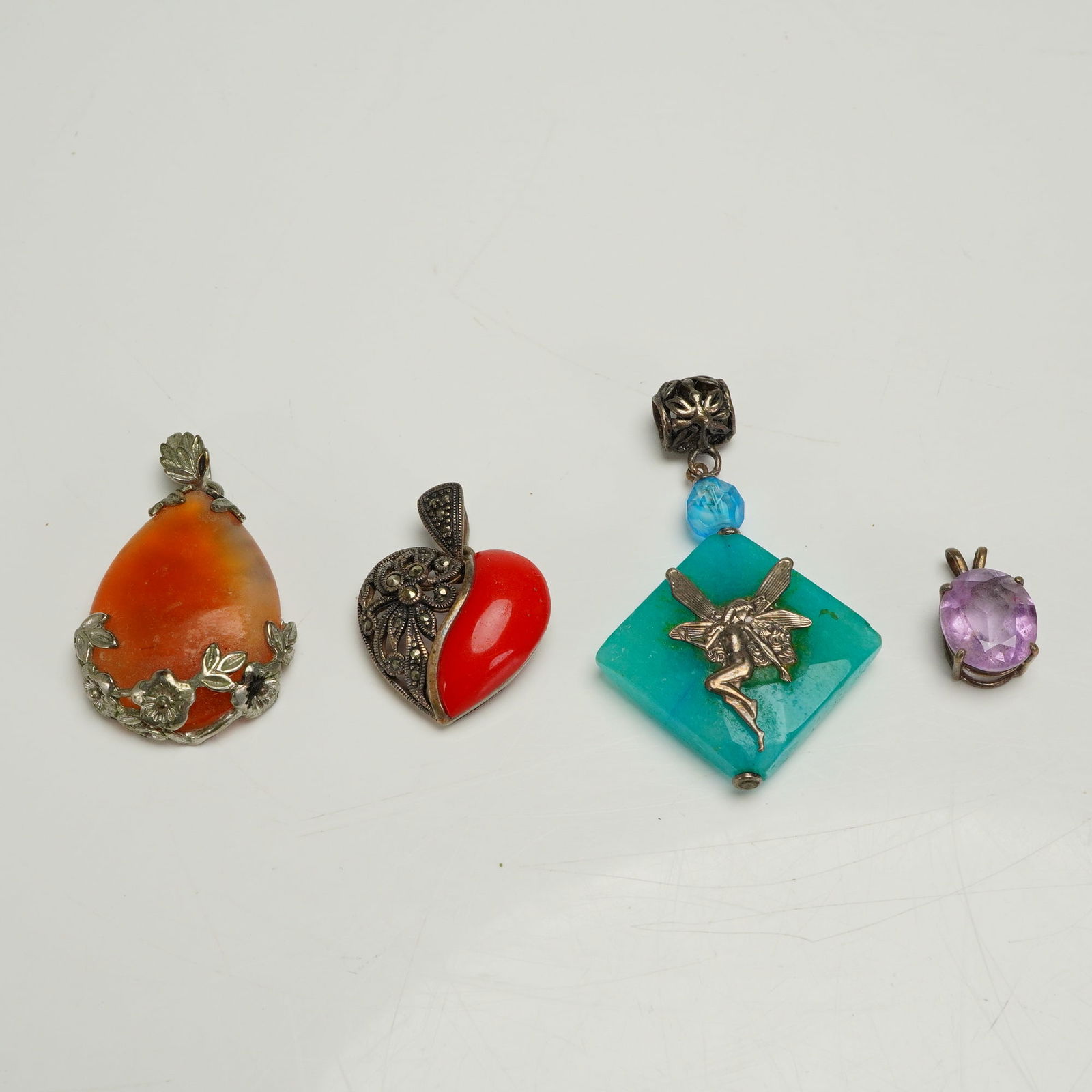 A Collection of Four Gem and Silver-Toned Pendants (1 of 4)
