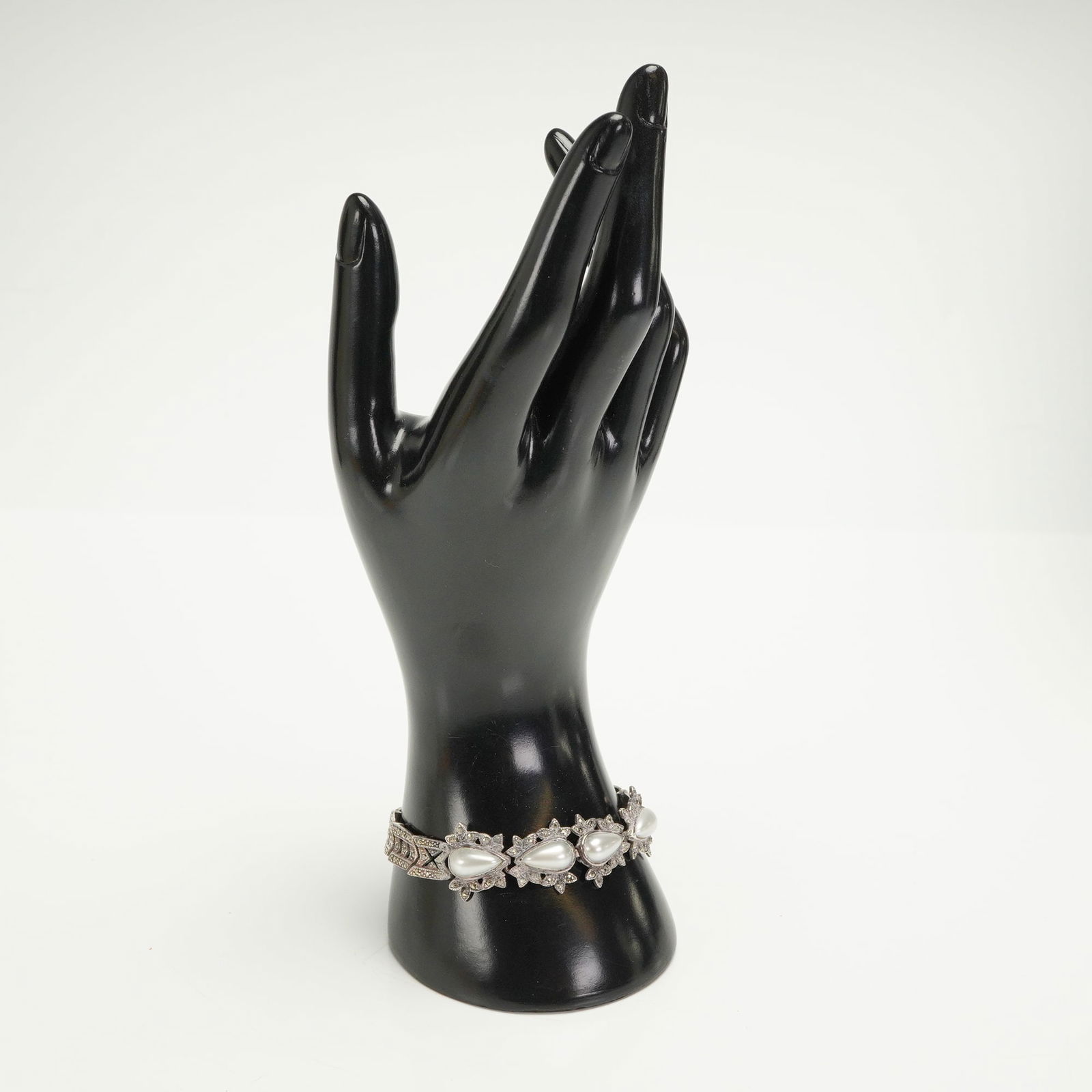 Sterling Silver Marcasite Link Bracelet: A sterling silver bracelet featuring an Art Deco-revival or retro design. The construction consists of linked segments secured by a box clasp mechanism, which bears a visible "925" hallmark confirming