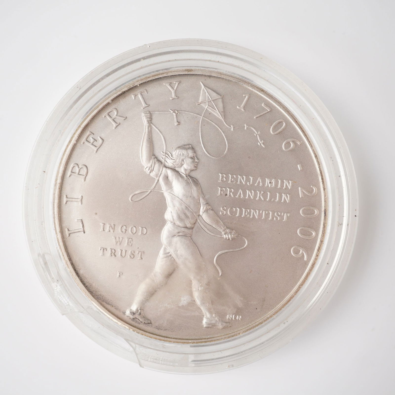 2006-P Benjamin Franklin Tercentenary Scientist One Dollar Silver Coin: A commemorative silver coin issued by the United States Mint in Philadelphia to honor the 300th anniversary of Benjamin Franklin's birth. Struck in 0.900 fine silver, the obverse features a depiction
