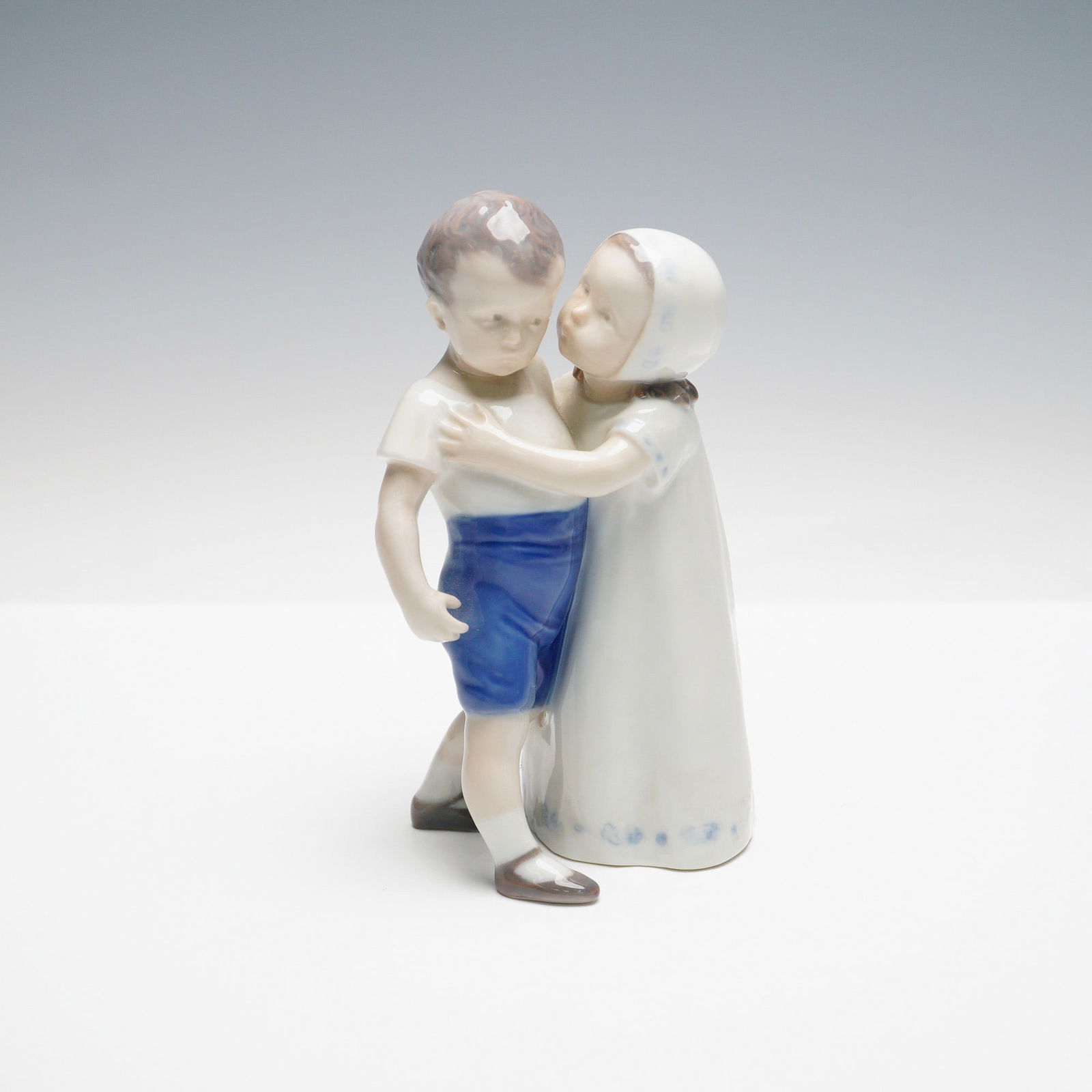 Bing & Grondahl Porcelain Children Figurine, Love Refused: This poignant Bing & Grondahl porcelain figurine, titled Love Refused, was designed by Ingeborg Plockross Irminger. The figurine beautifully captures a tender yet emotional moment between a boy and a