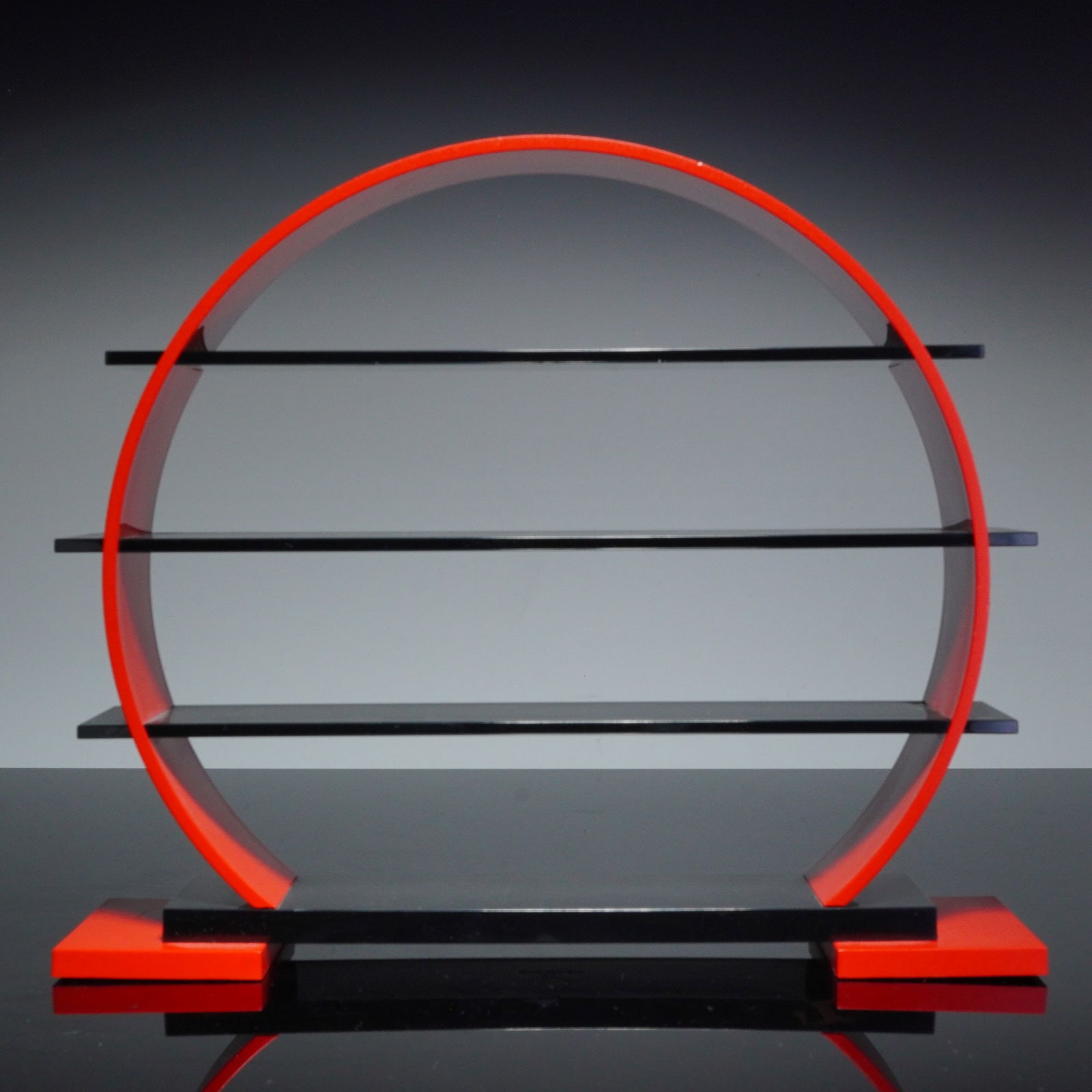 Swarovski Chinese Zodiac Display Stand: Swarovski Chinese Zodiac display stand, model 290359. The stand features a circular red frame with three integrated black tiered shelves. The base is designed with a central black plinth over two red