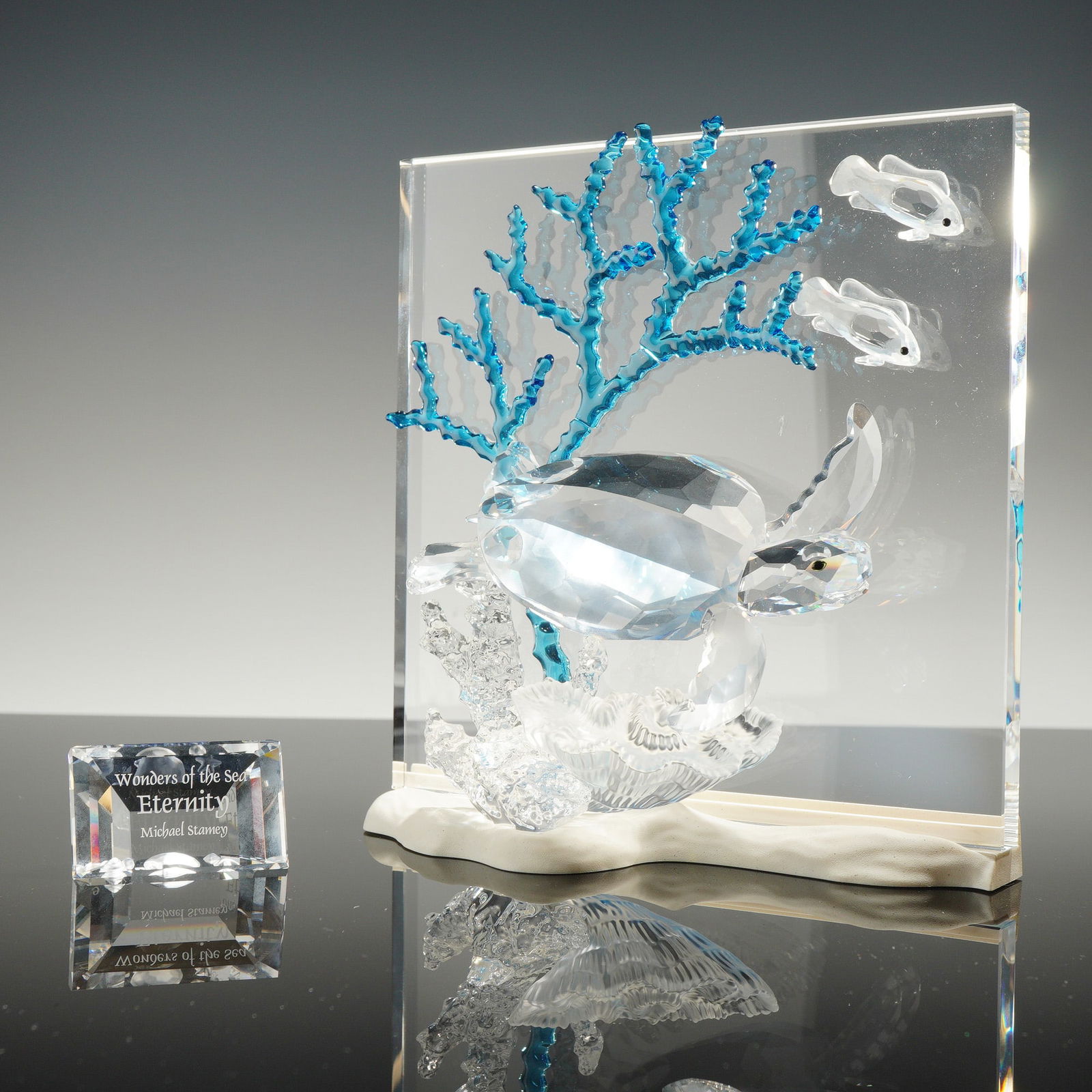 Collection of Swarovski Crystal Wonders of the Sea Eternity Turtle Items: A collection of Swarovski Wonders of the Sea Eternity crystal items designed by Michael Stamey. The primary sculpture features a multi-faceted clear crystal sea turtle, two smaller fish, and a branch