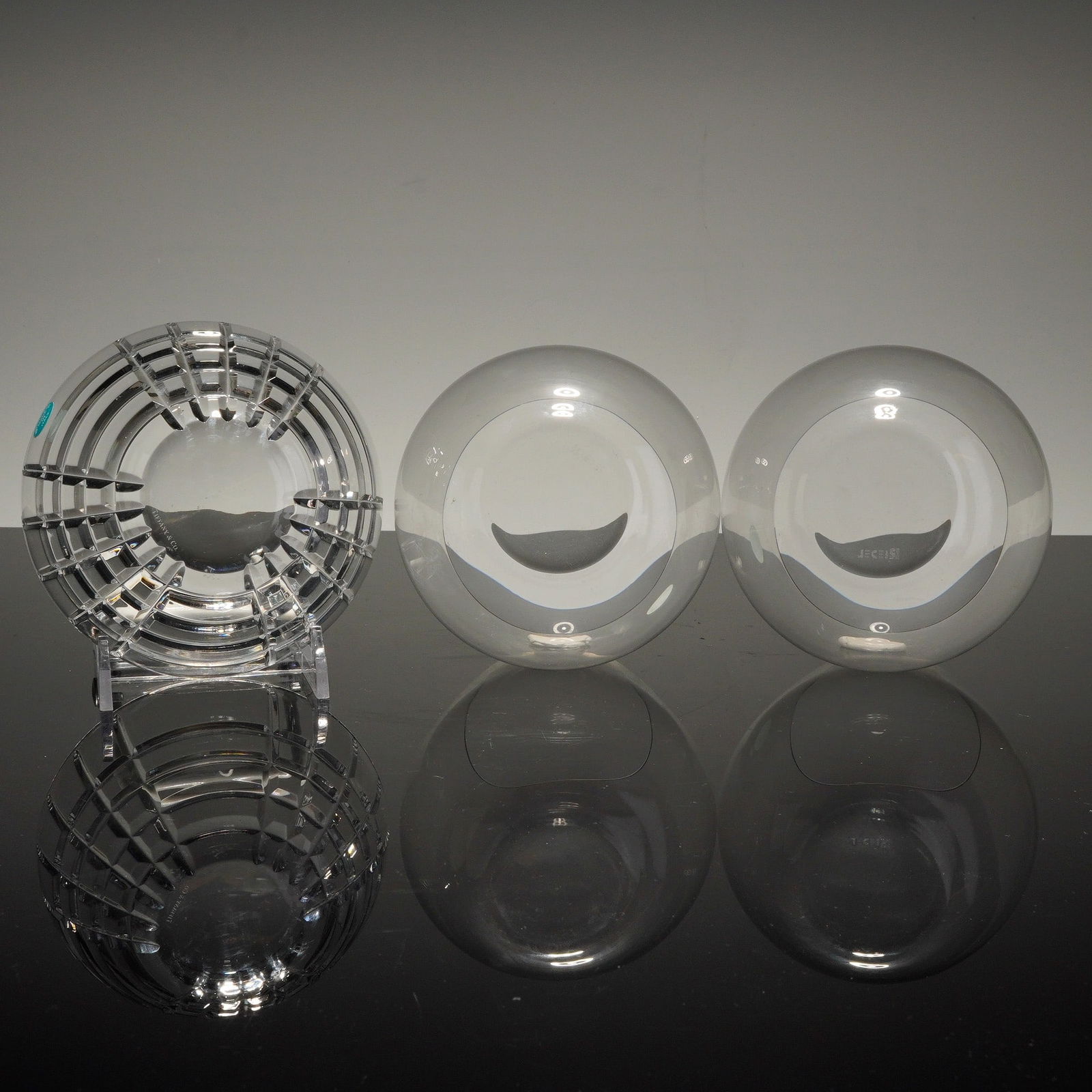 3pc Tiffany & Co. Crystal Dish and Josef Riede Stemless Glasses: Collection includes a crystal dish featuring a square-cut grid pattern, retaining its original teal manufacturer's sticker marked "Tiffany & Co. Made in Italy," and engraved "Tiffany & Co." to the und