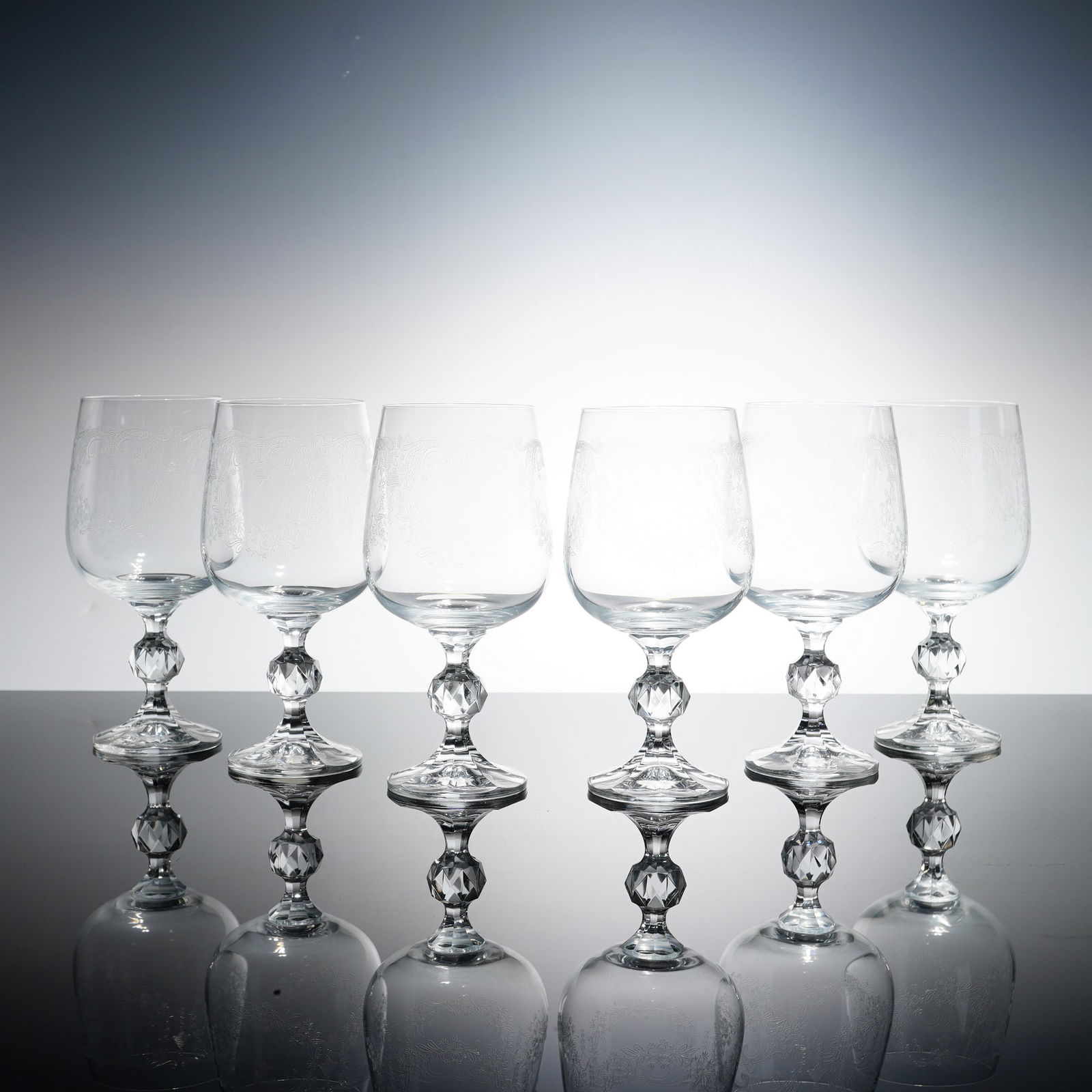 6pc Bohemia Clear Crystal Etched Wine Goblets: Crystal wine goblets in the Cascade pattern, featuring vintage needle-etched decoration. Each goblet is composed of a rounded, slightly tapered bowl embellished with an intricate band of scrolling fol